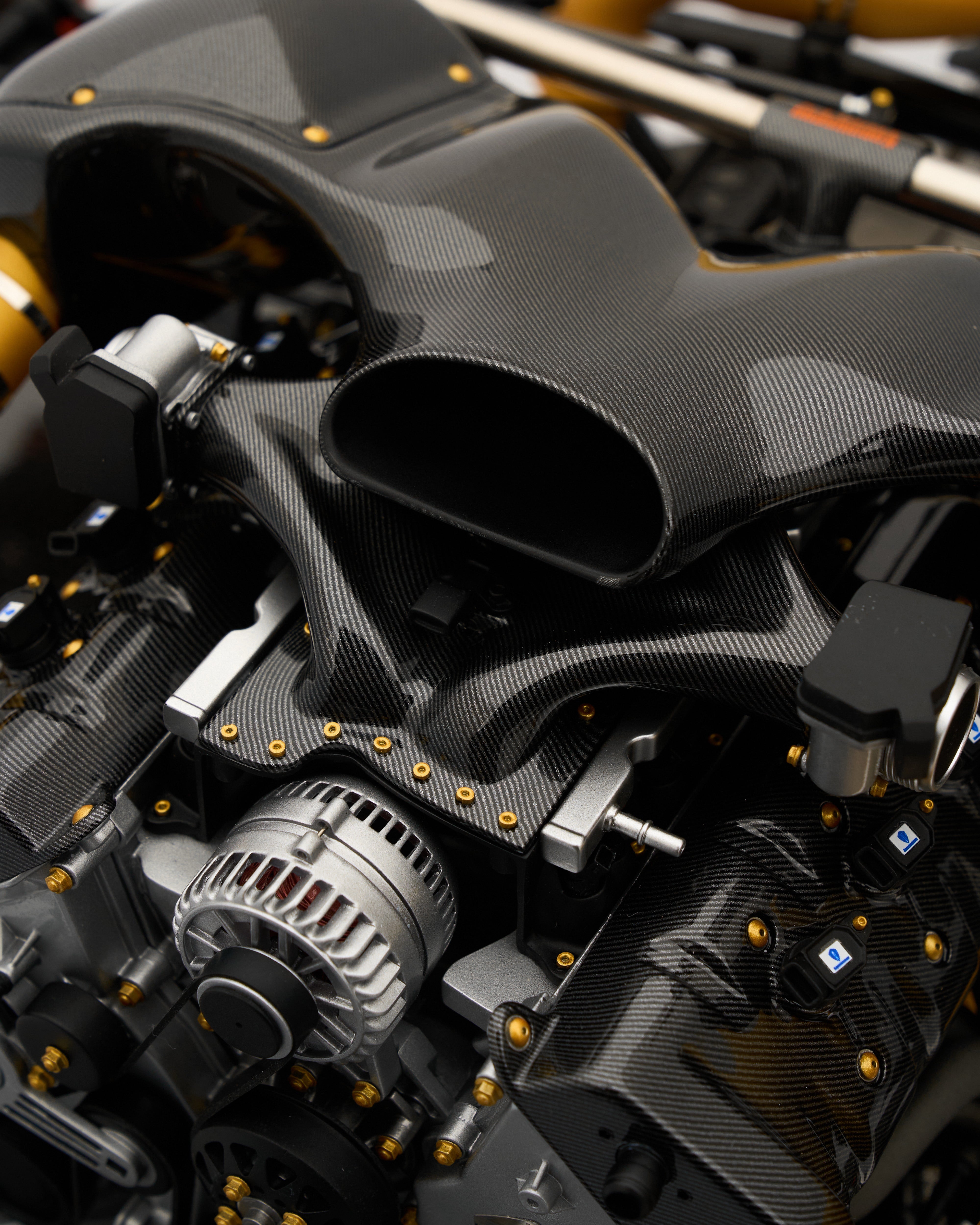 Close-up of Koenigsegg One:1 Engine Scale Model highlighting engine texture and intricate detailing with carbon fibre