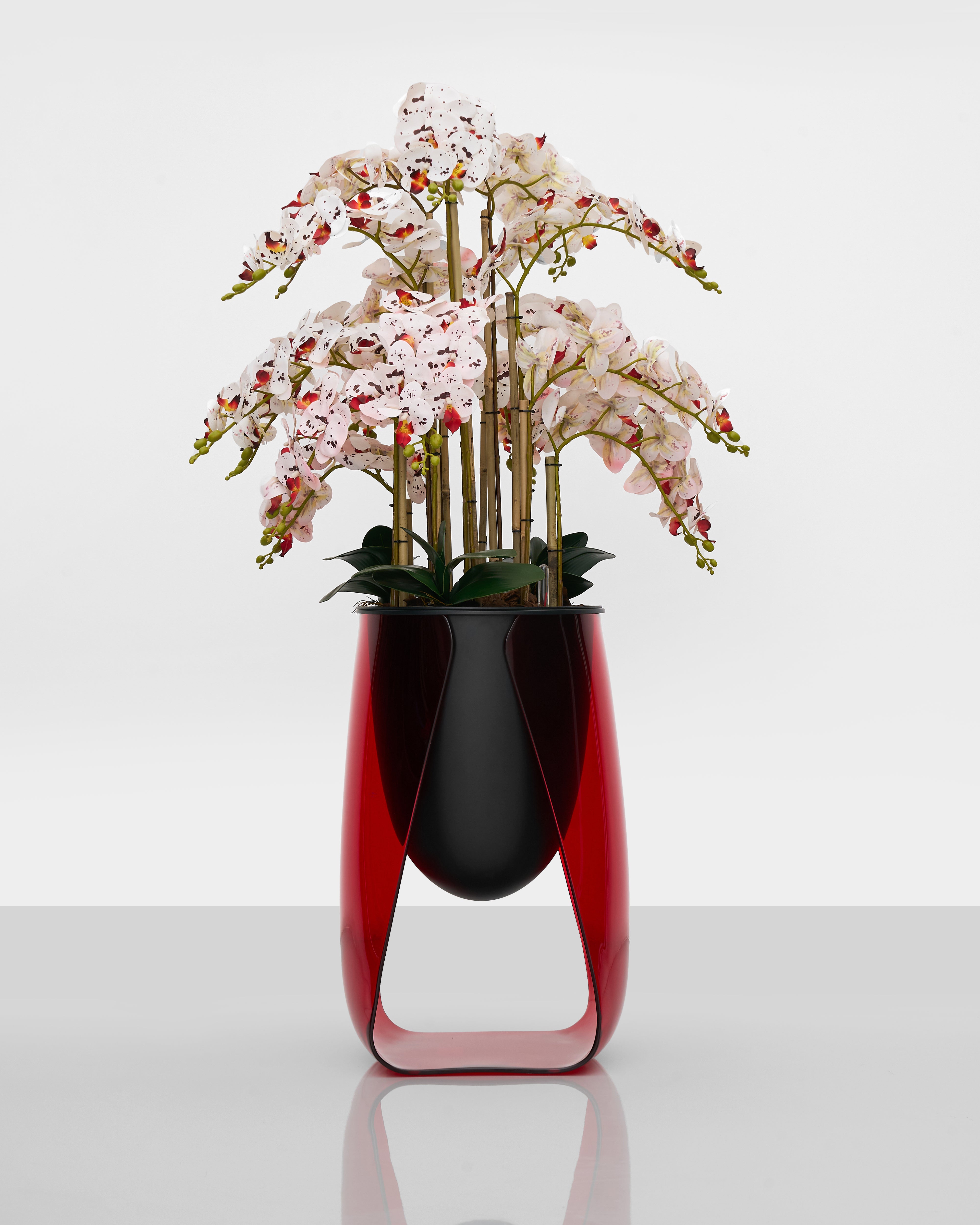 Lark Planter luxury home accent in striking red with gracefully curved stand and glazed finish
