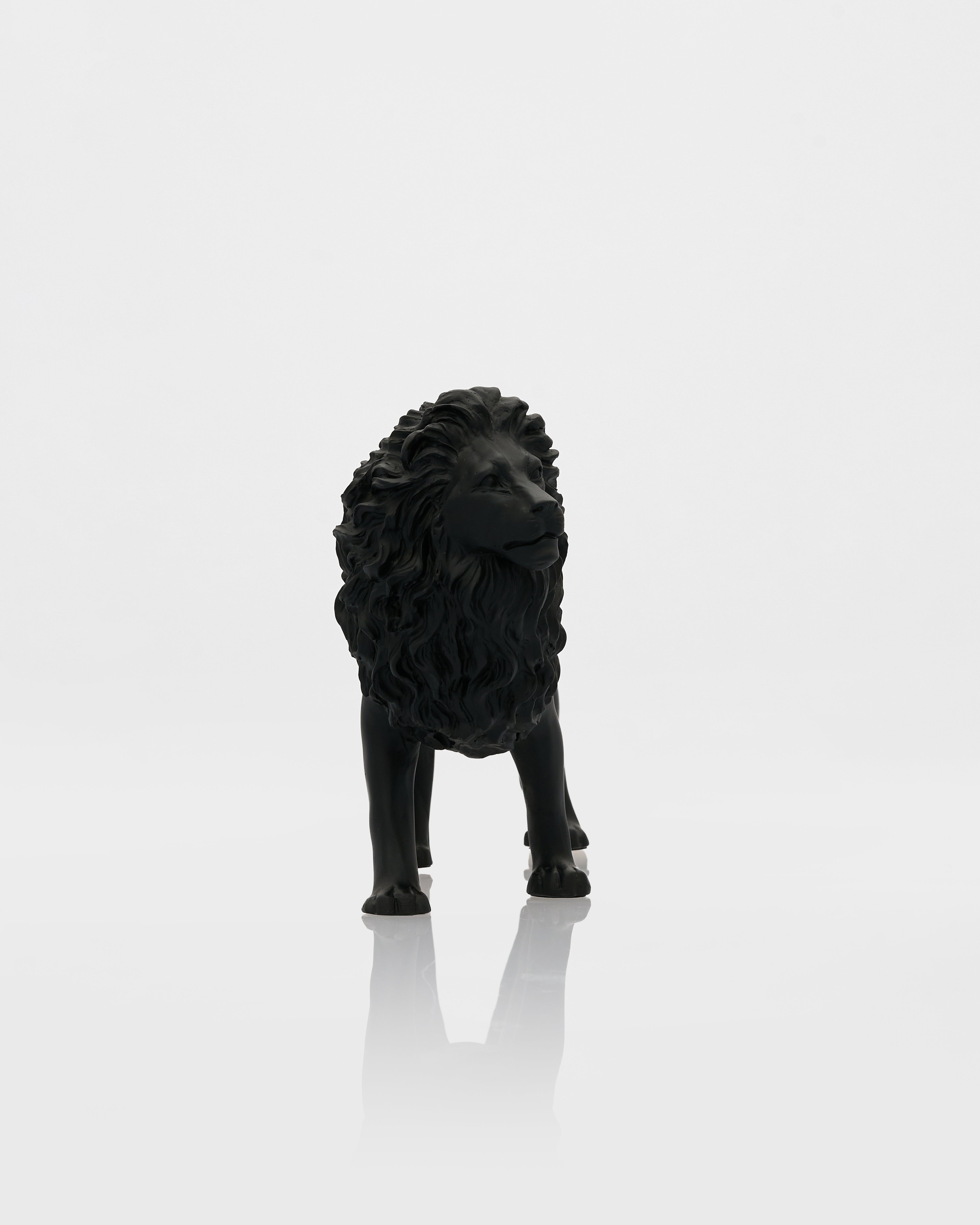 Black lion statue on a white background