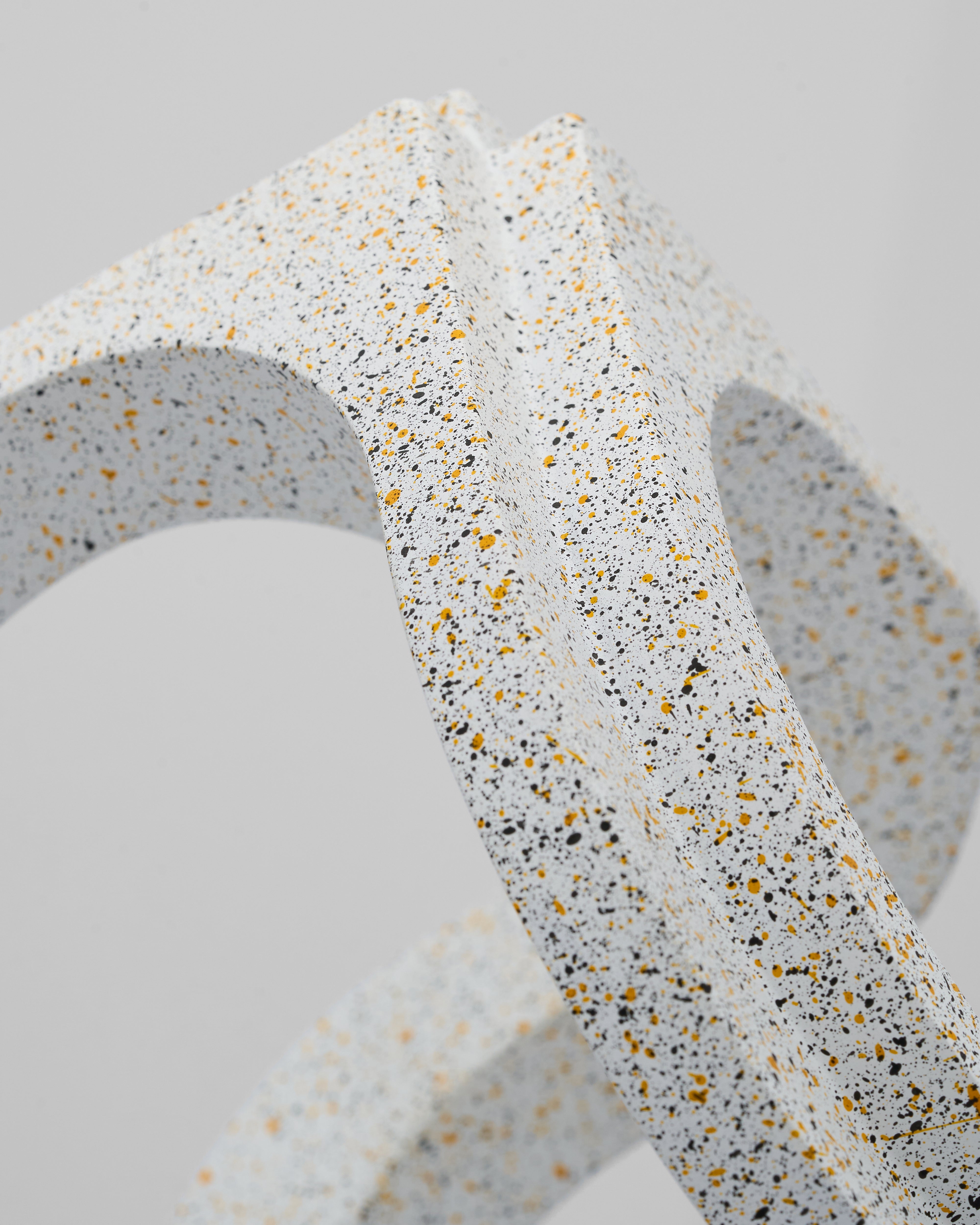 Close-up of Loom Infinity Ceramic Decor detailing smooth ceramic texture and marble foundation