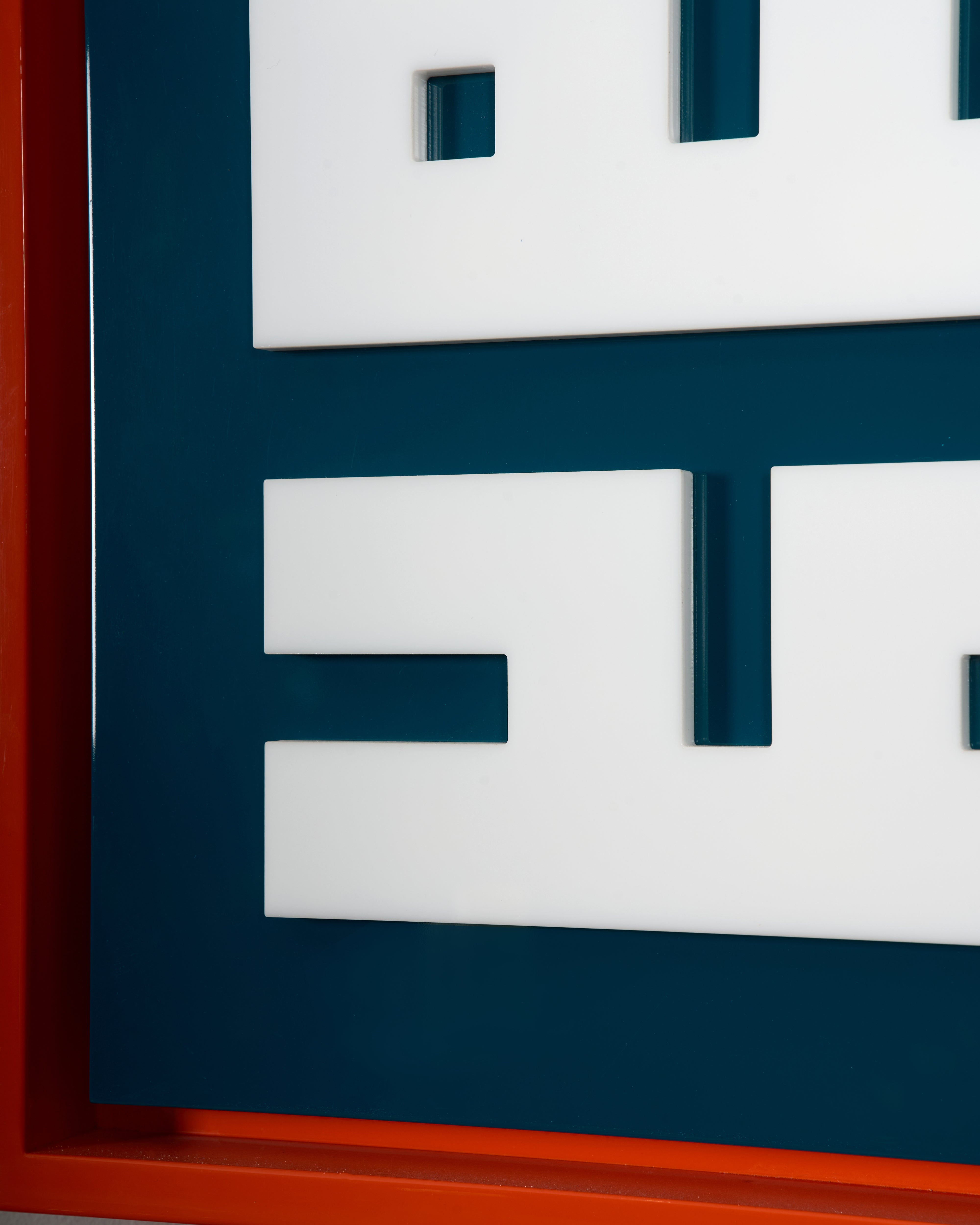 Geometric arabic calligraphic art with blue, white, and orange colors on a dark blue background