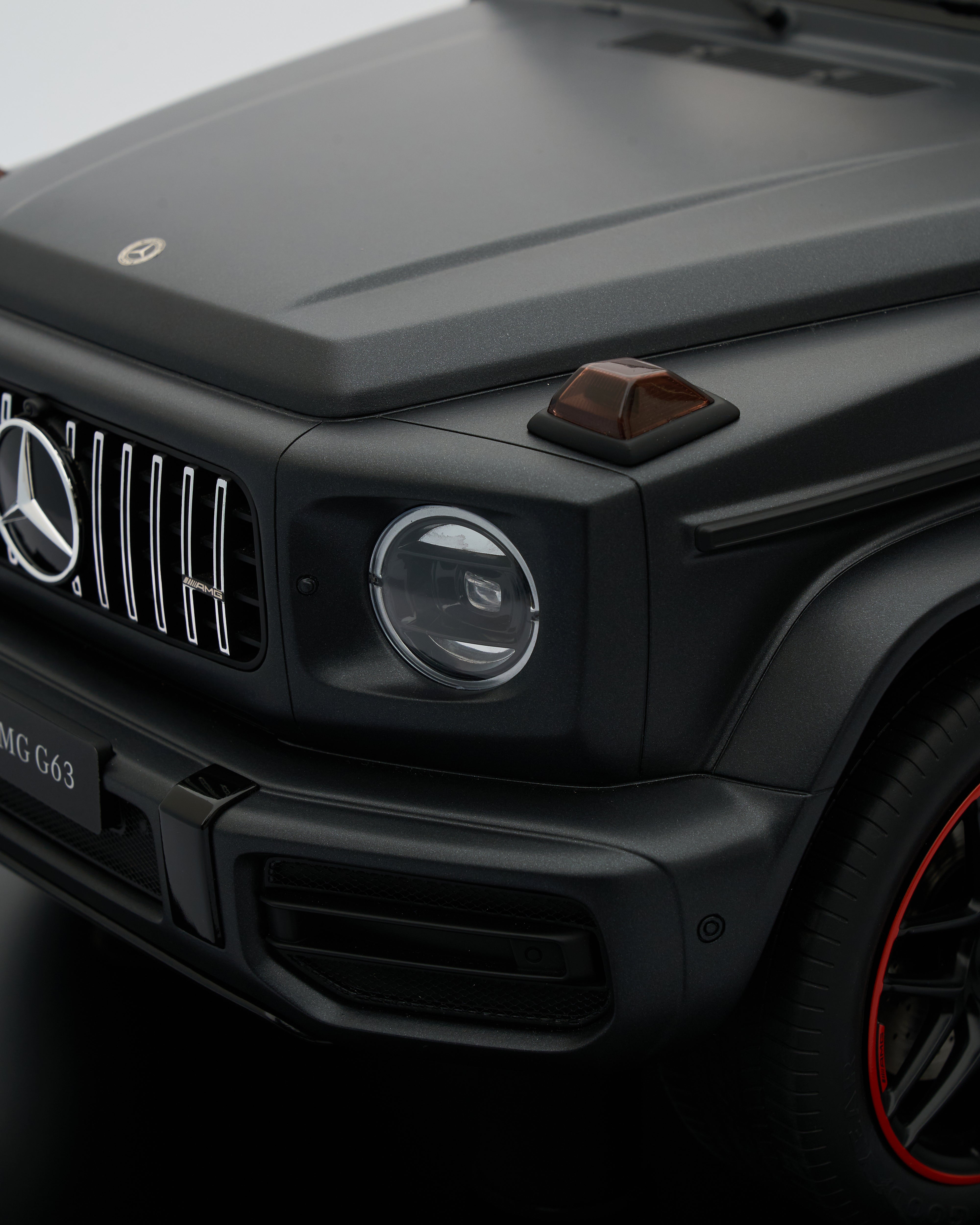 Close-up of a black Mercedes-Benz vehicle with visible logo.