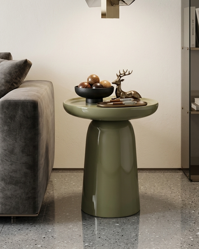 Modern living room with a gray sofa, green side table, and decorative items.