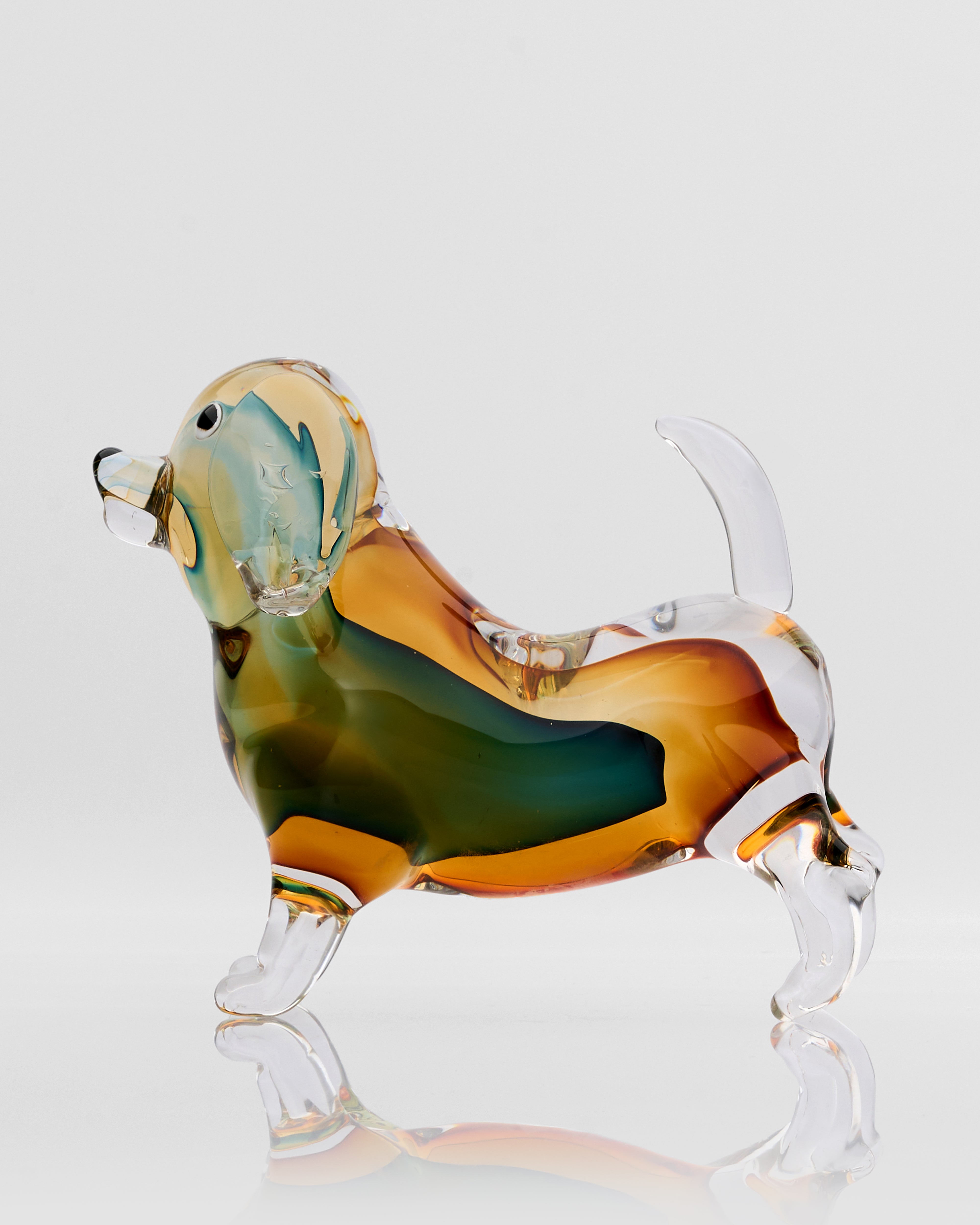 Glass dog figurine with a multicolored body on a white background