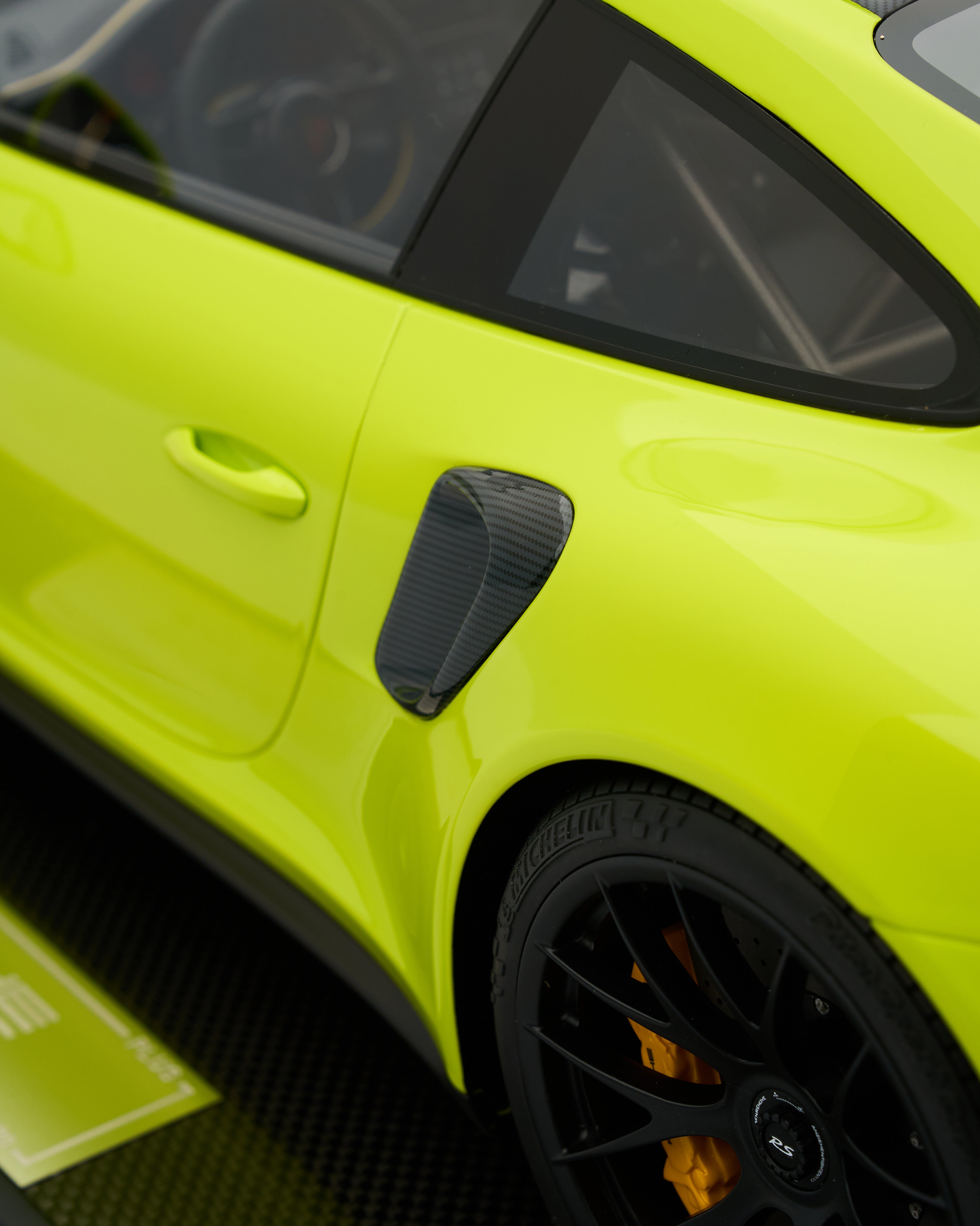 Close-up of a bright yellow car with black accents