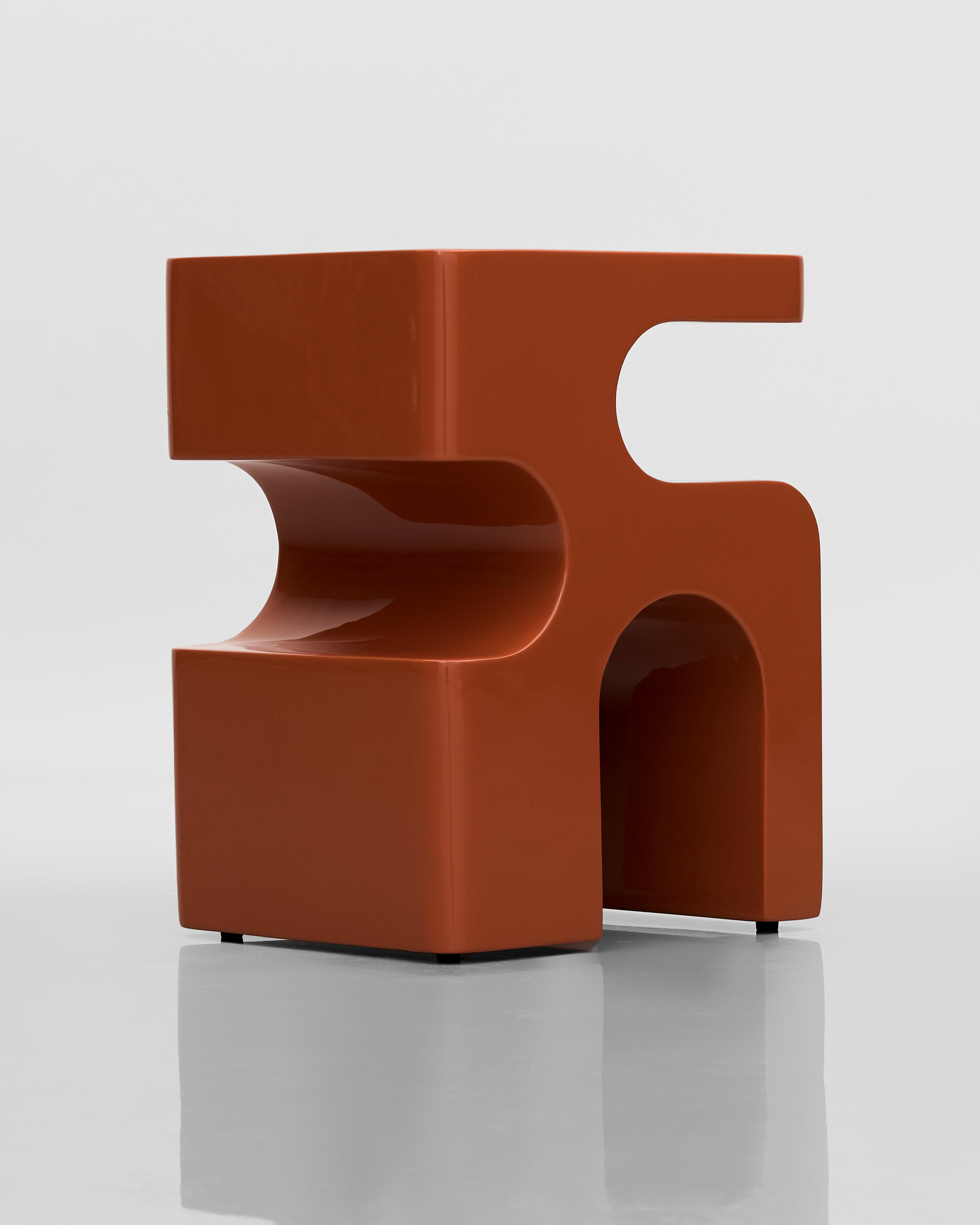 Modern brown chair with a unique design on a white background