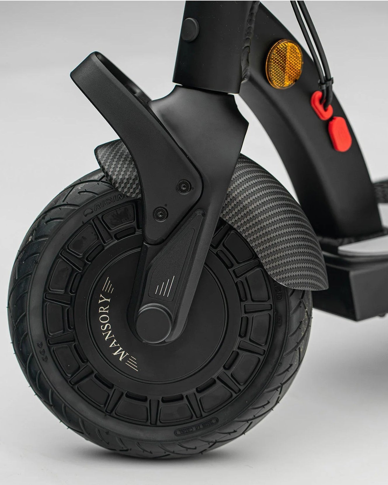 Close-up of a scooter wheel with visible branding on a gray background