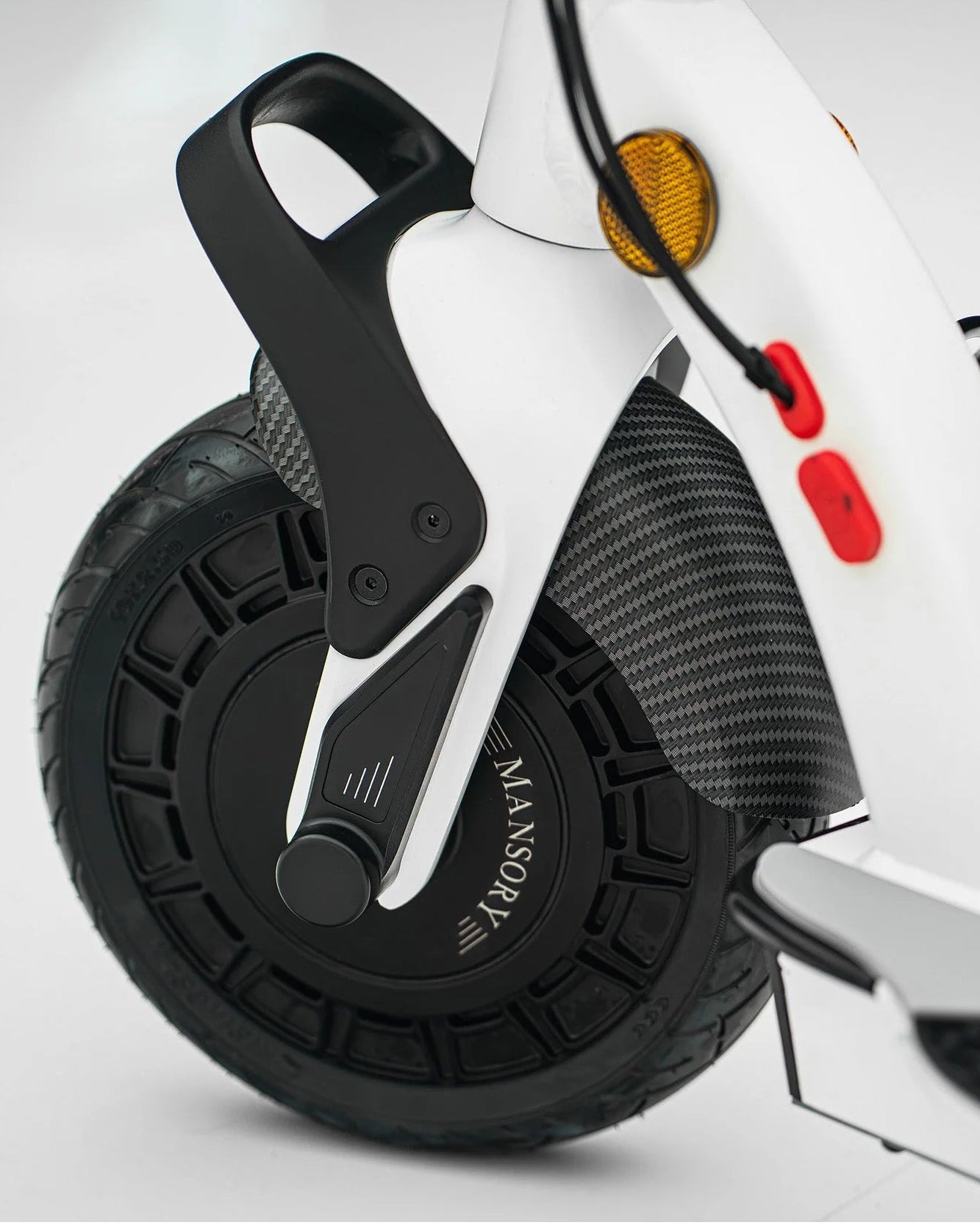 Close-up of a scooter wheel with 'Mansory' branding on a white background