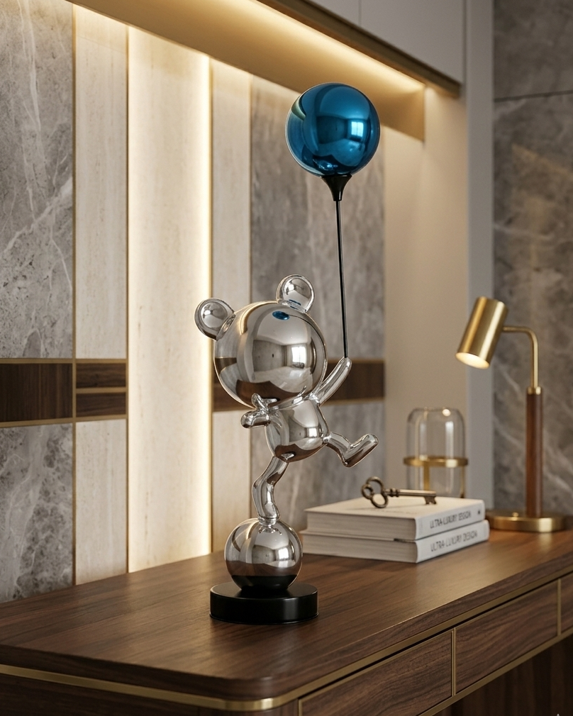 Decorative table lamp with a blue shade on a wooden surface against a marble wall.