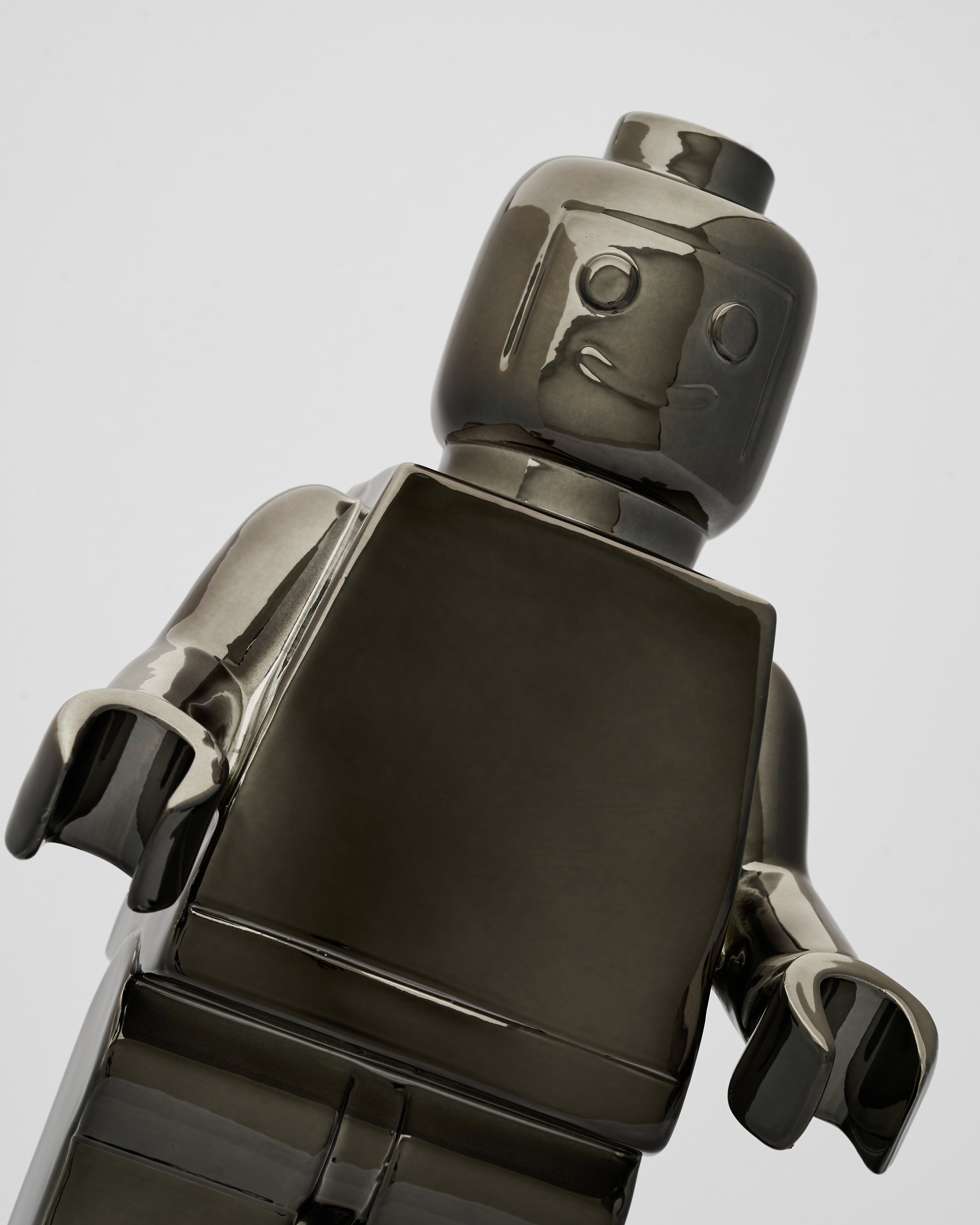 Close-up of a metallic robot figure on a light gray background