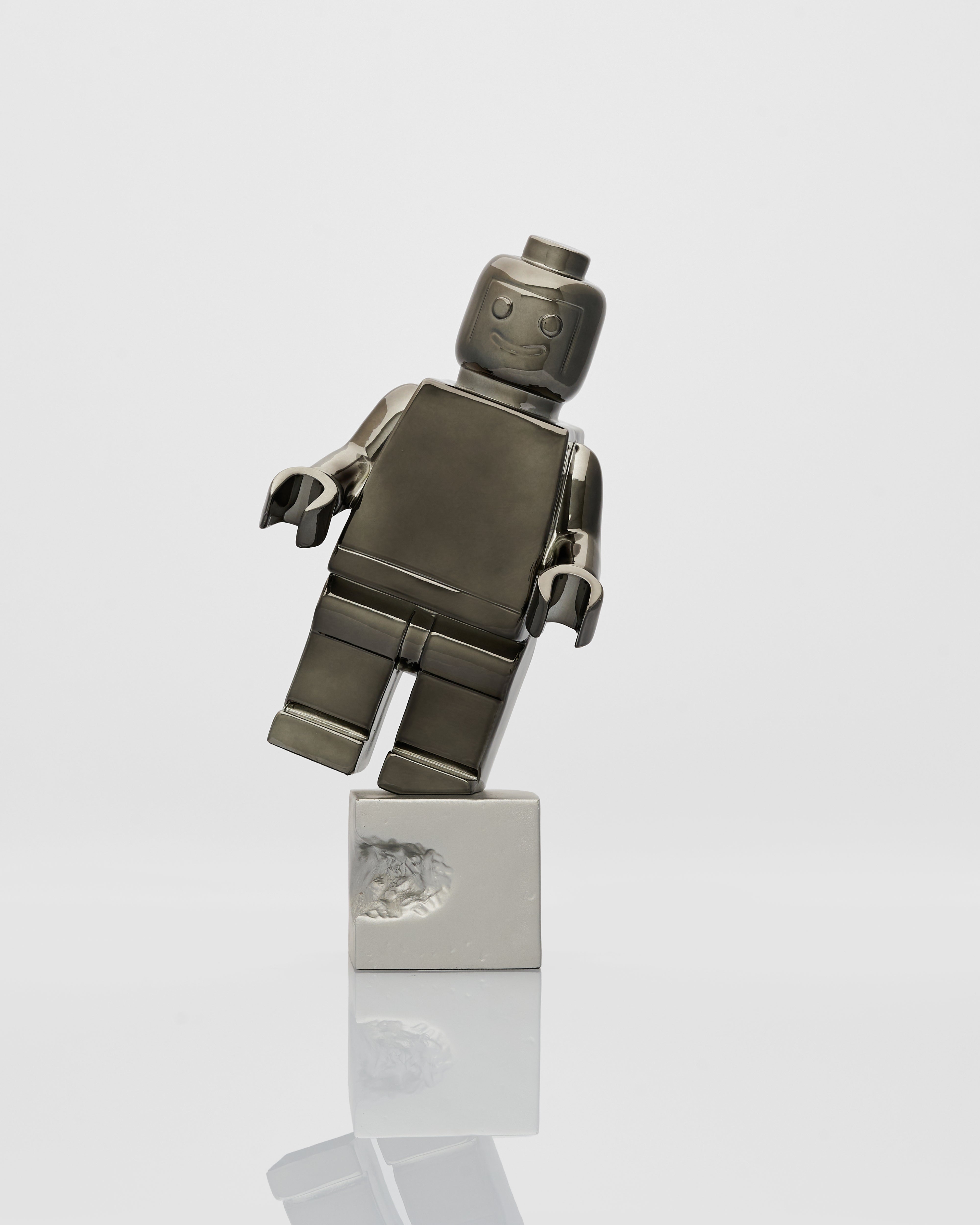 Metallic robot figurine on a white background