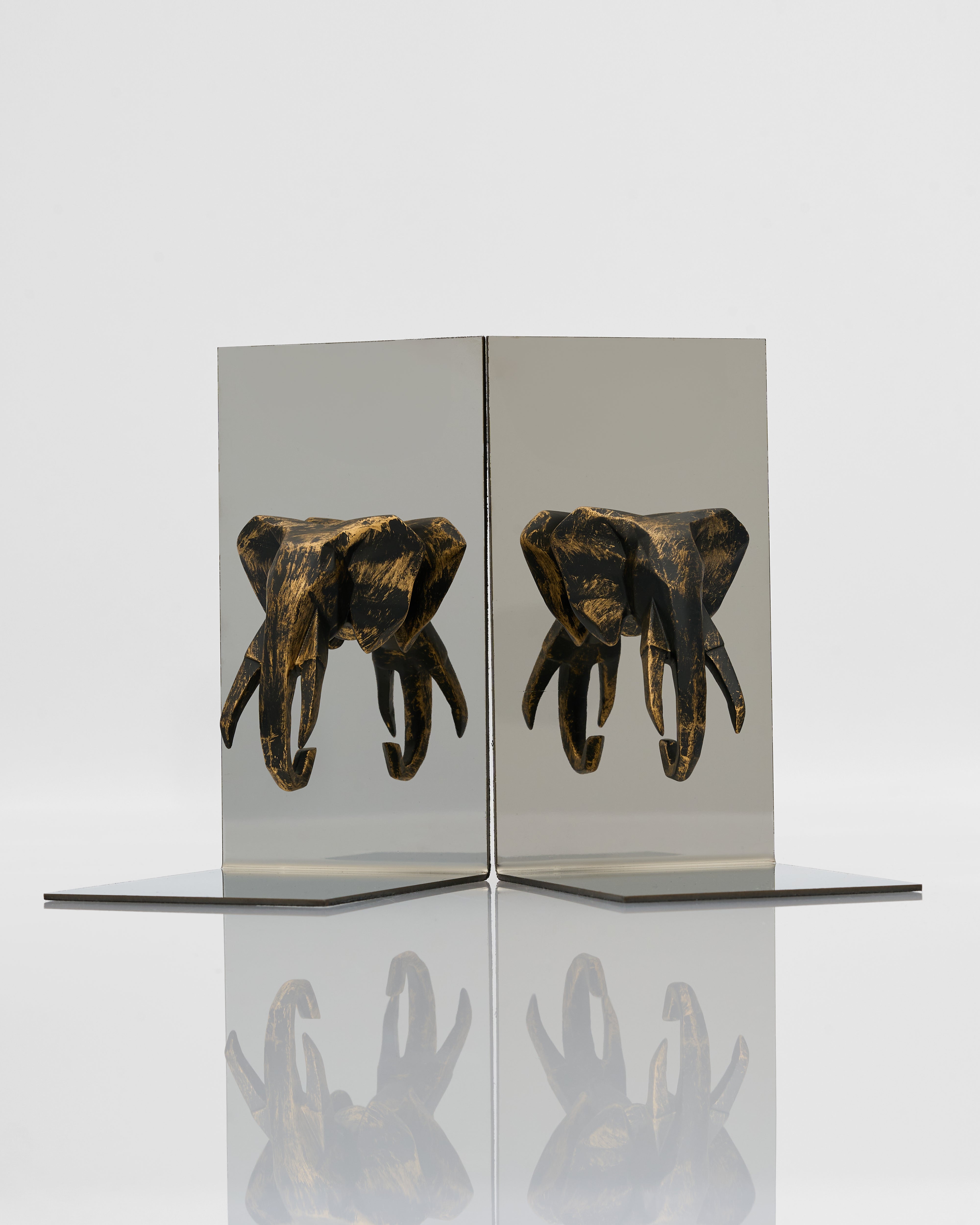 Decorative item with elephant heads on a reflective surface