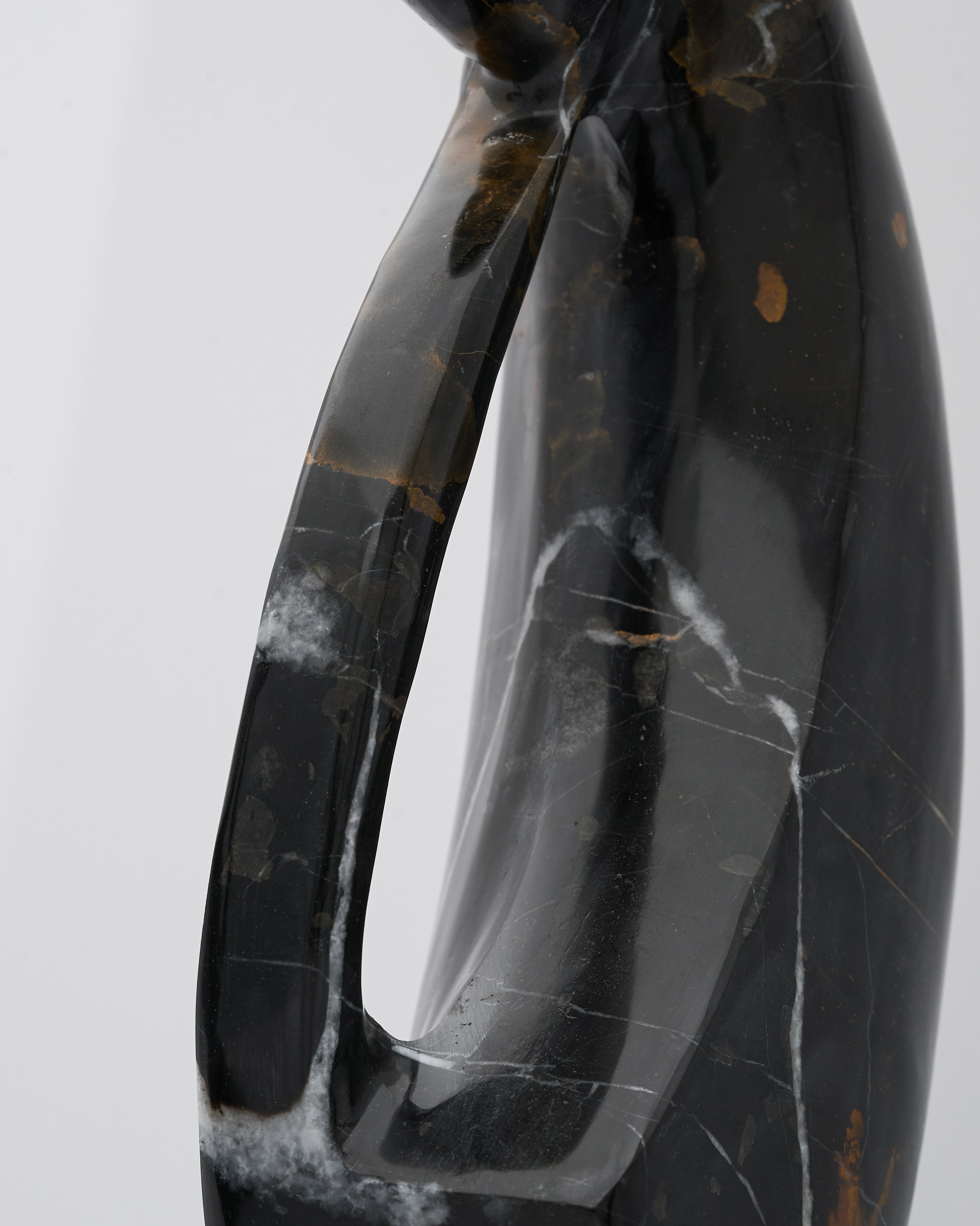 Black marble vase with visible veins on a light gray background