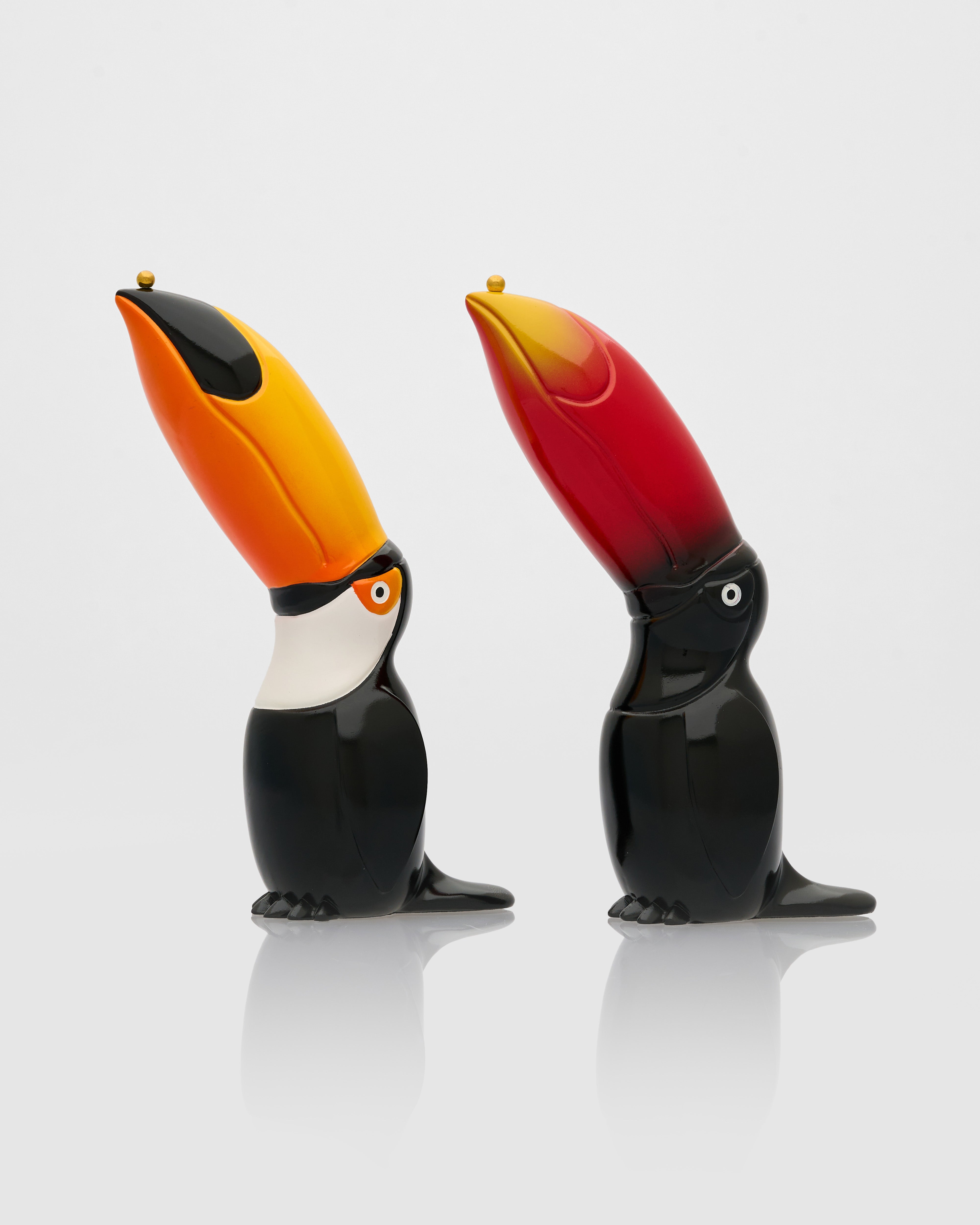 Two toucan-shaped salt and pepper shakers on a white background