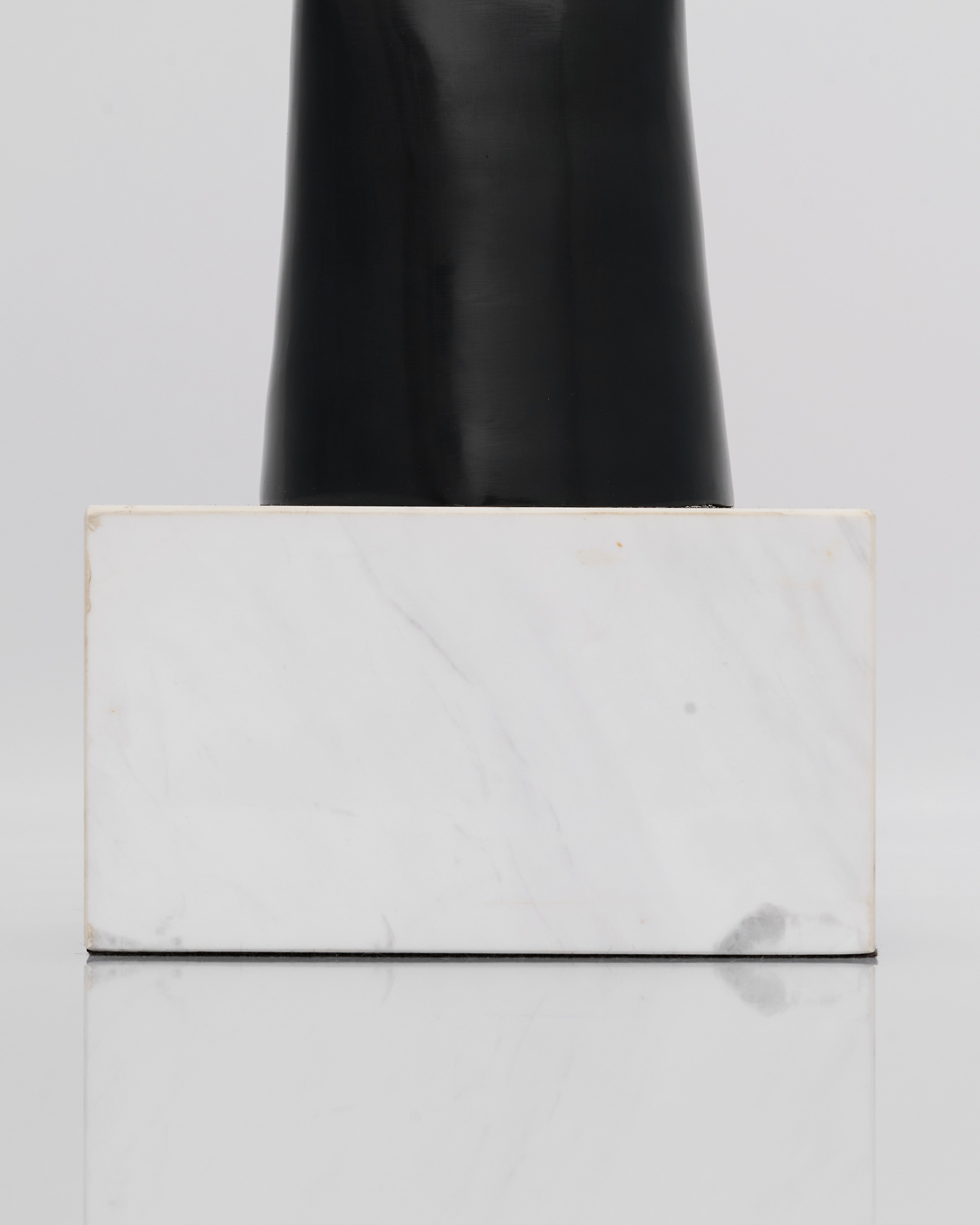 White marble-patterned box with gold accents on a light gray background