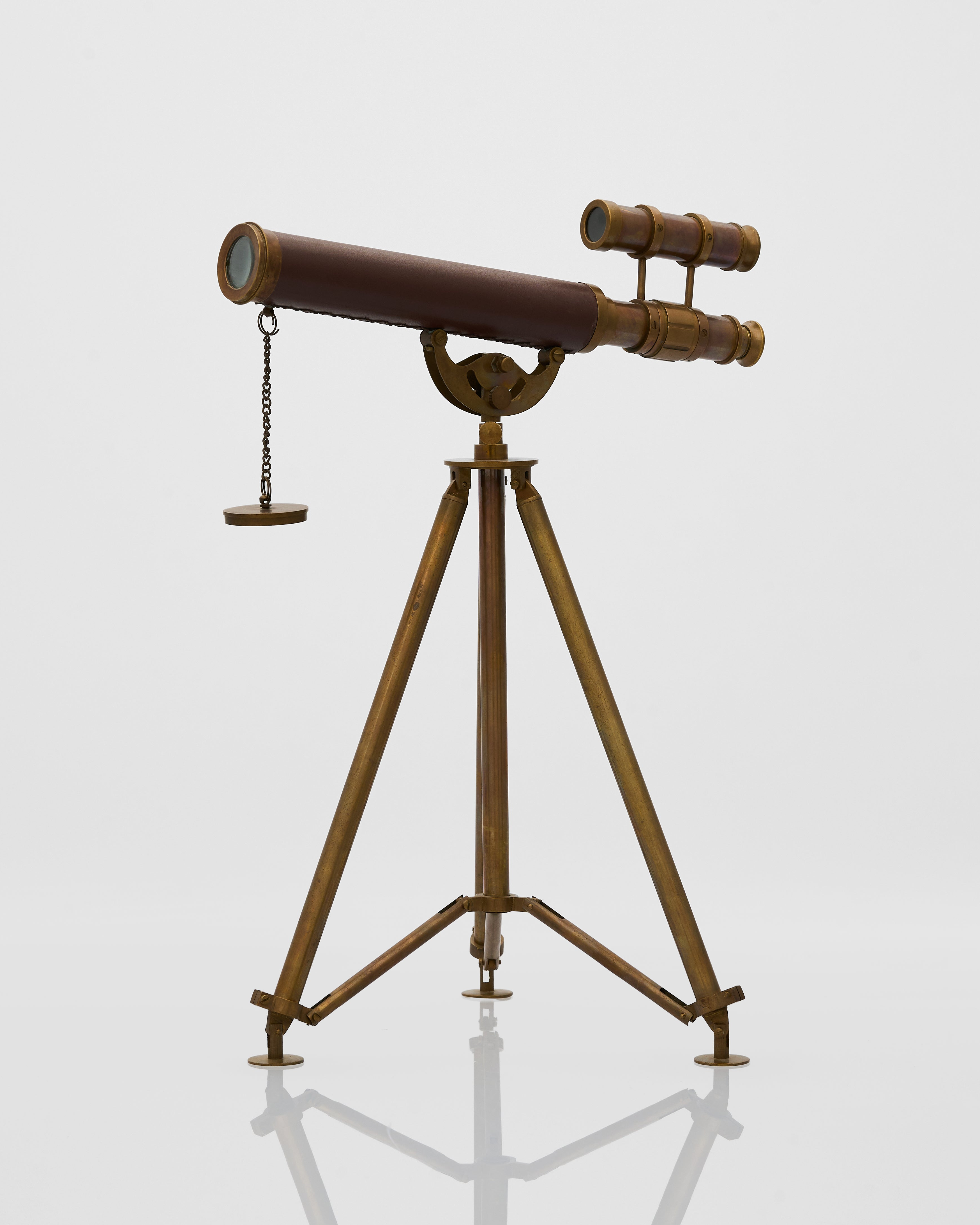 Vintage-style telescope on a stand against a light gray background