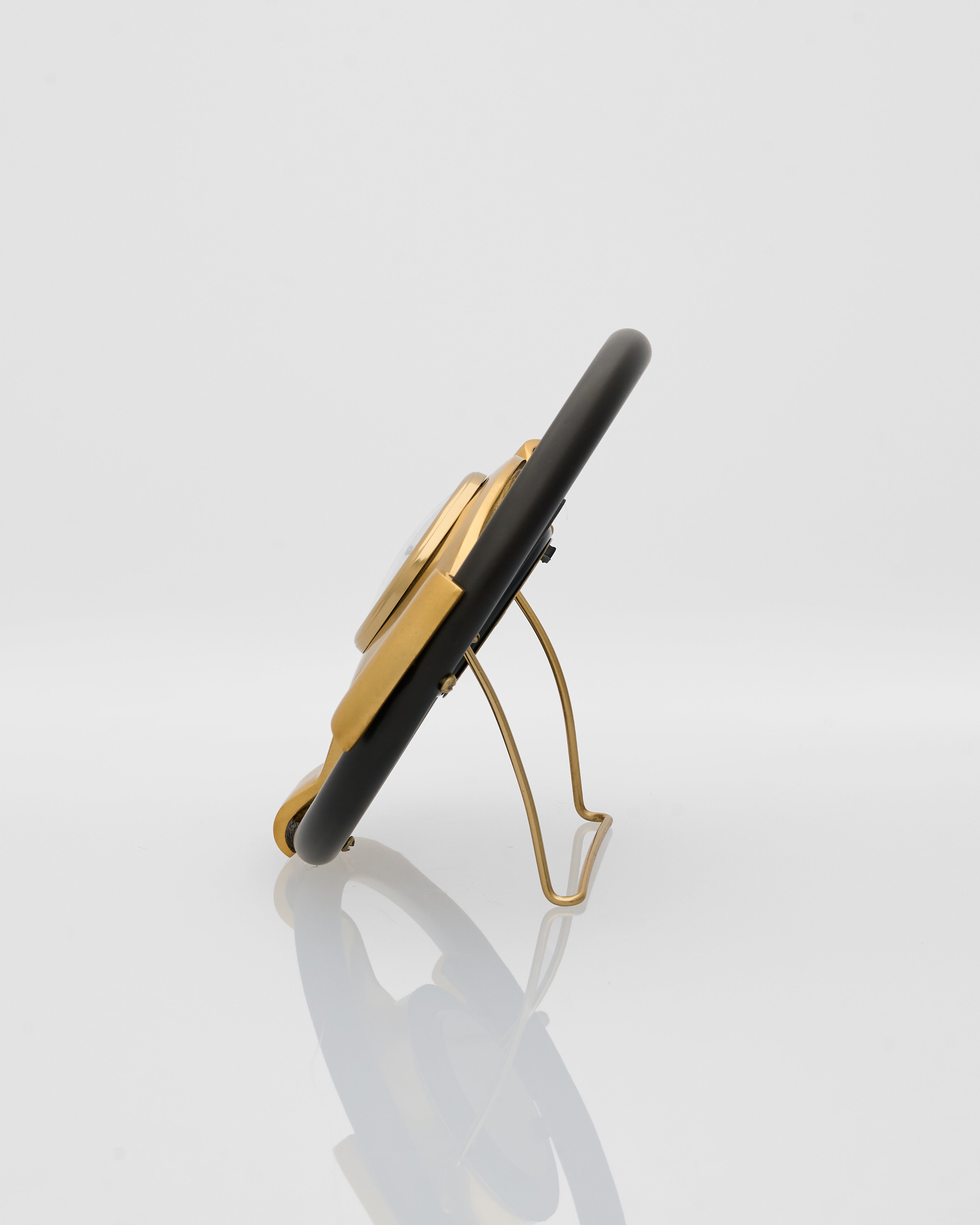 Gold and black phone stand on a white background