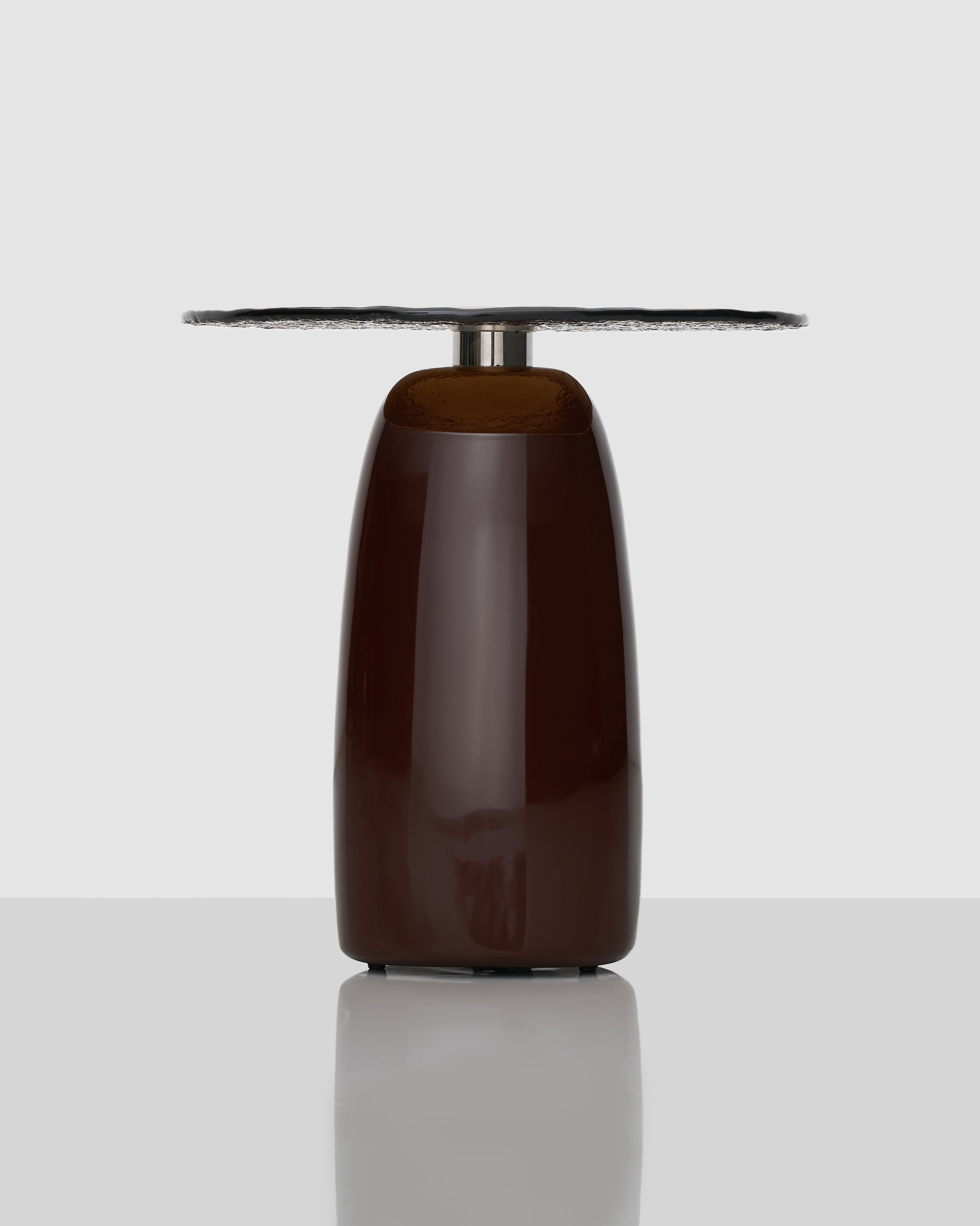 Side view of Wave Marble Side Table highlighting sculptural undulating tabletop and elegant glass support