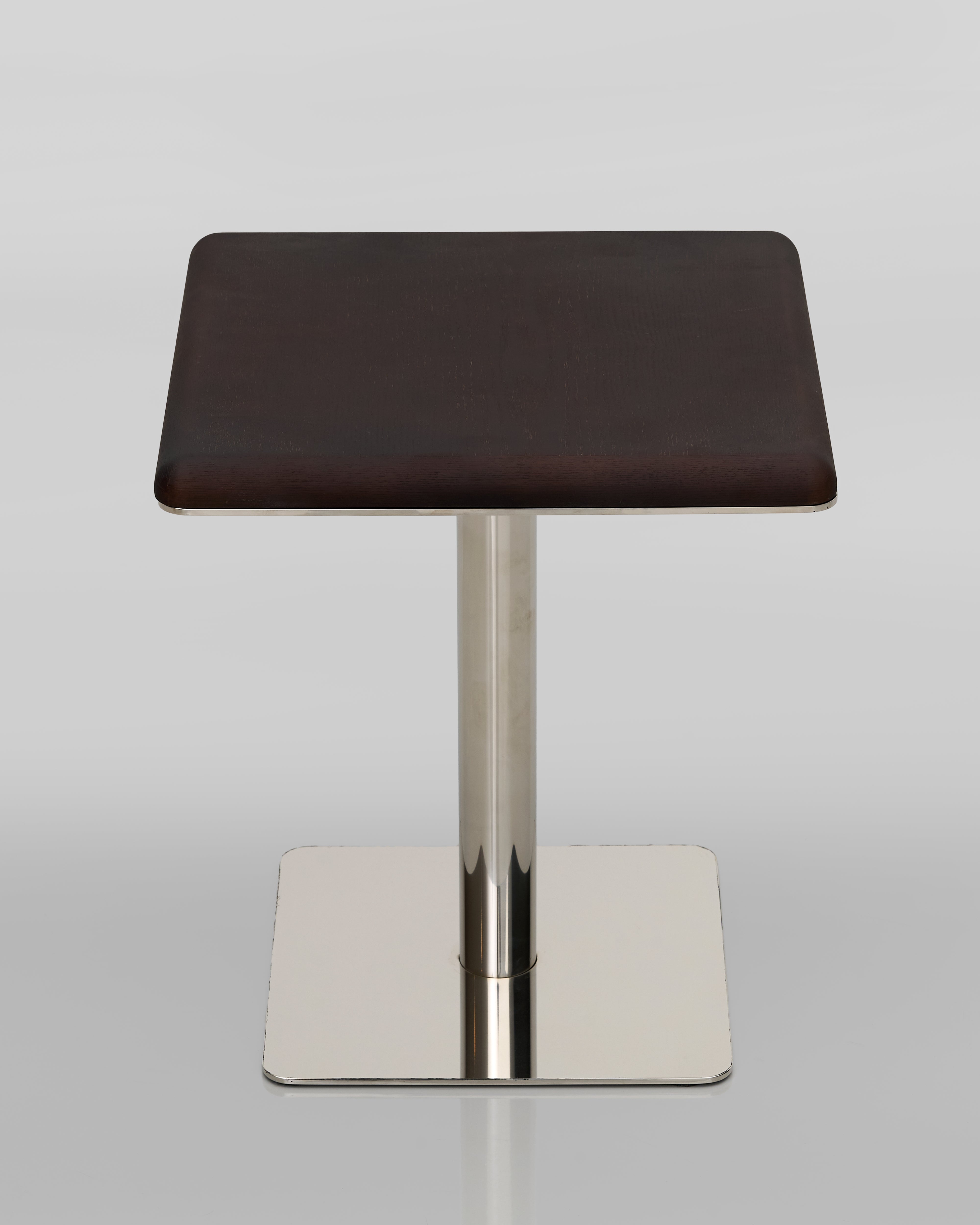Side view of wooden base side table highlighting sculptural silhouette and premium wood finish