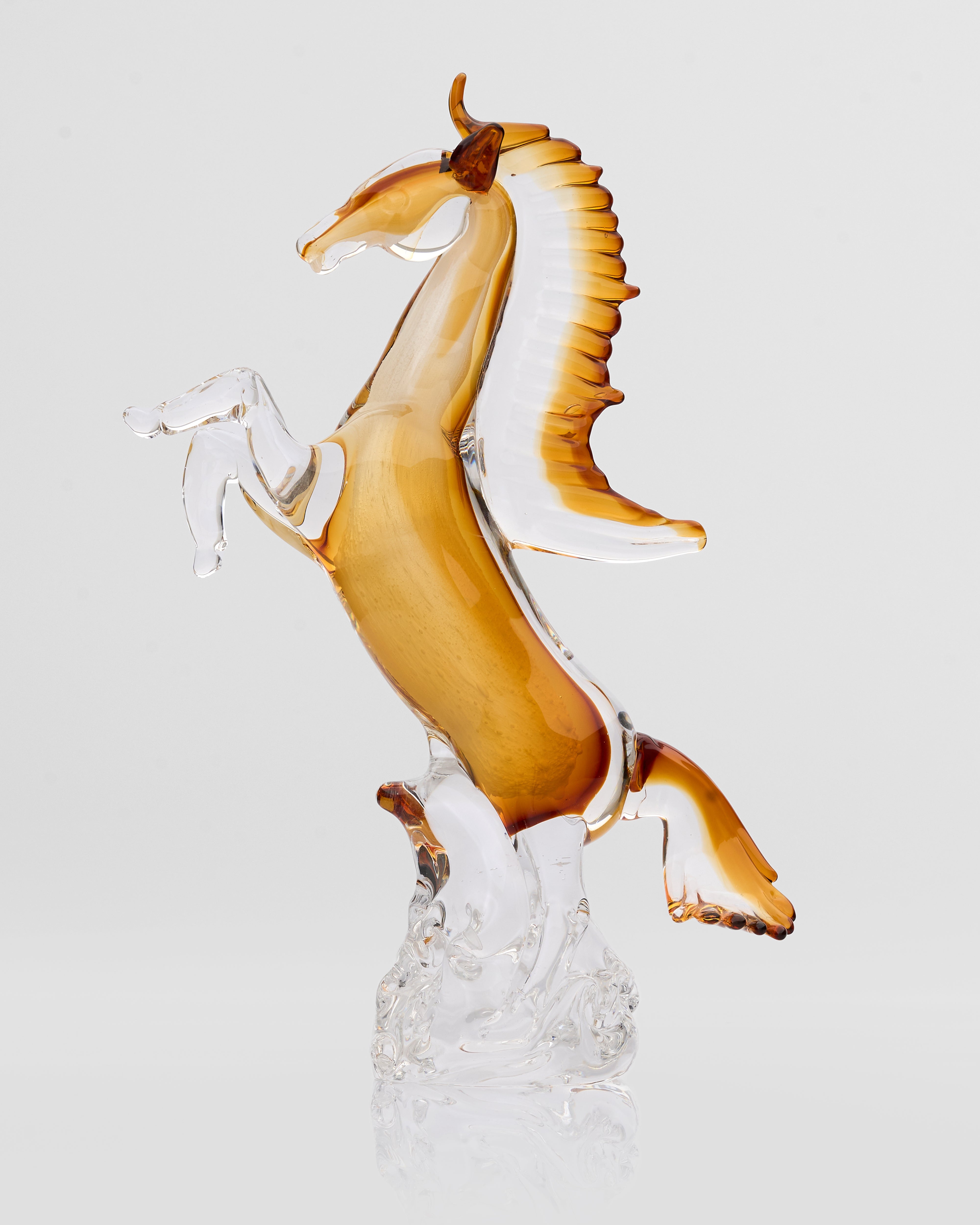 Glass sculpture of a horse on a white background