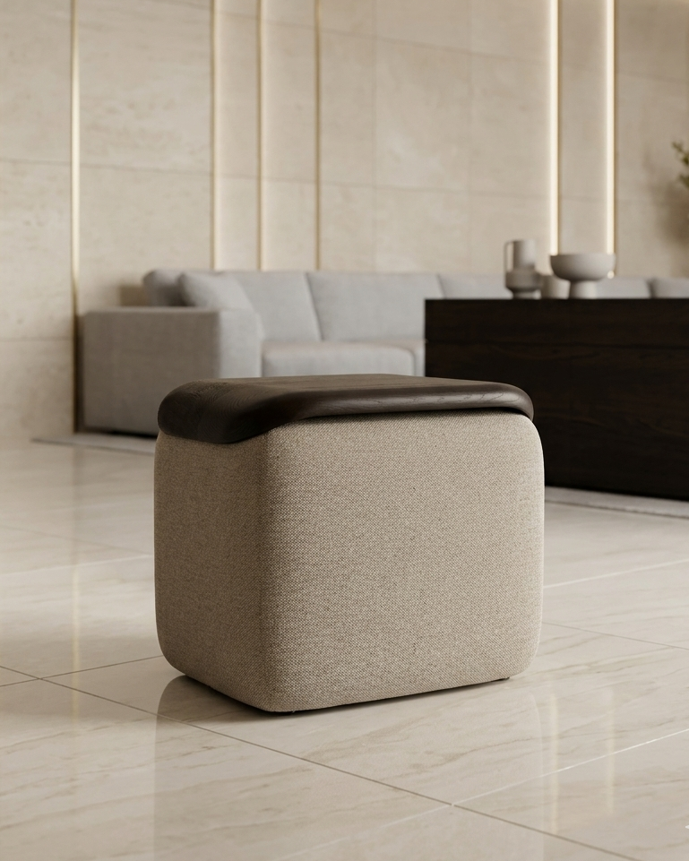 Beige ottoman with a brown top in a modern living room setting.