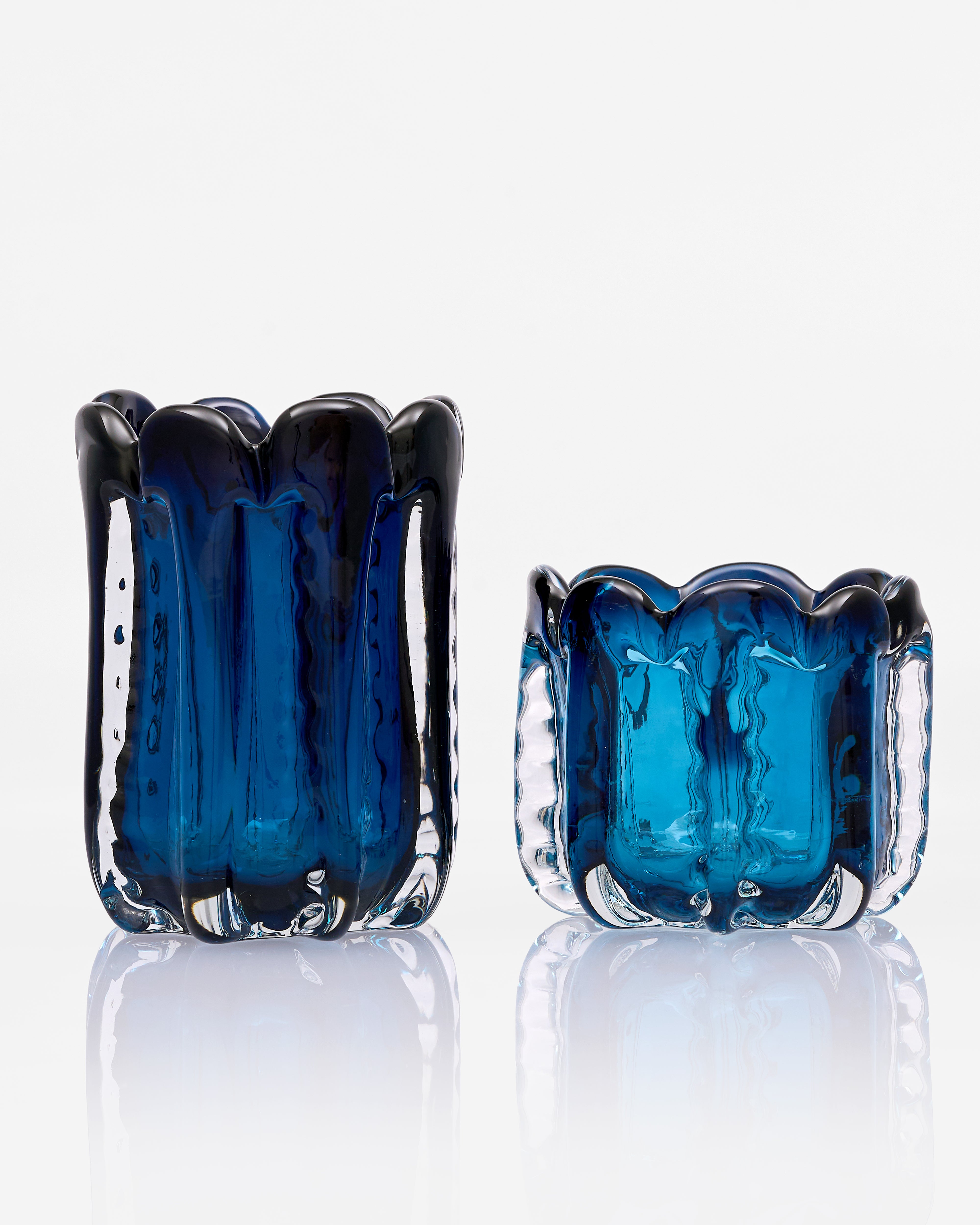 Pair of blue glass vases on a white background