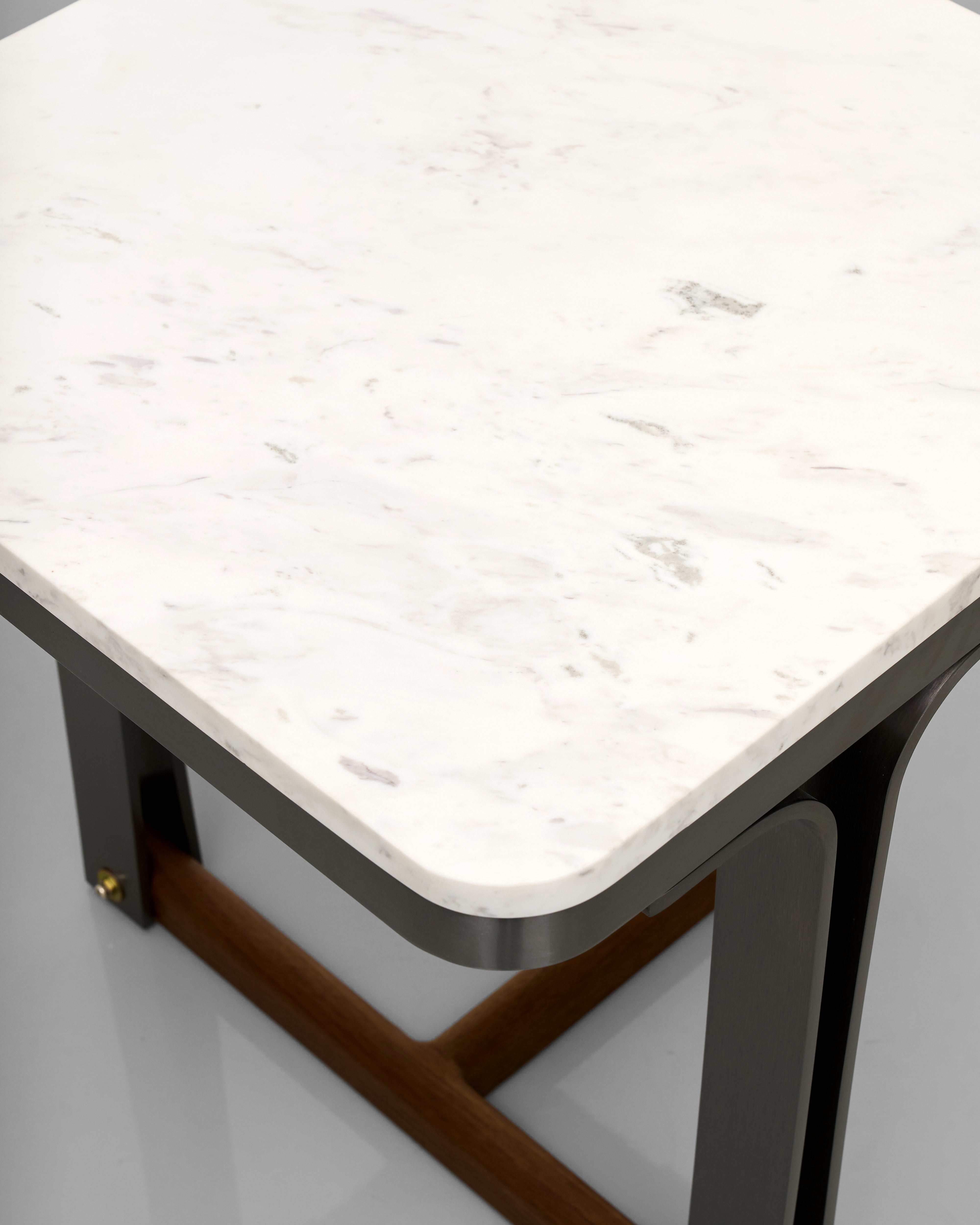 Table with marble-like top and metal frame on a light gray background