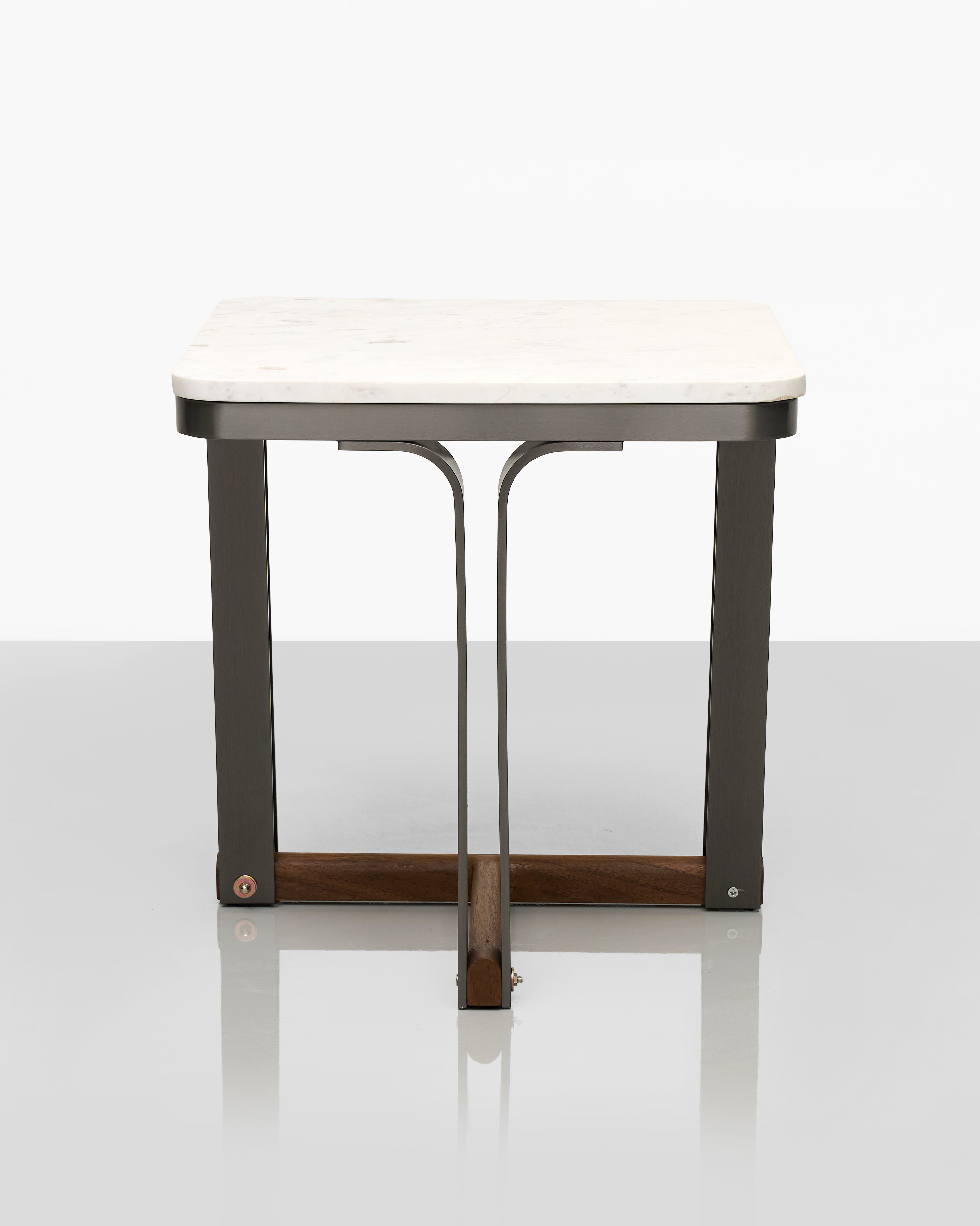 Small table with a white top and dark metal frame on a white background