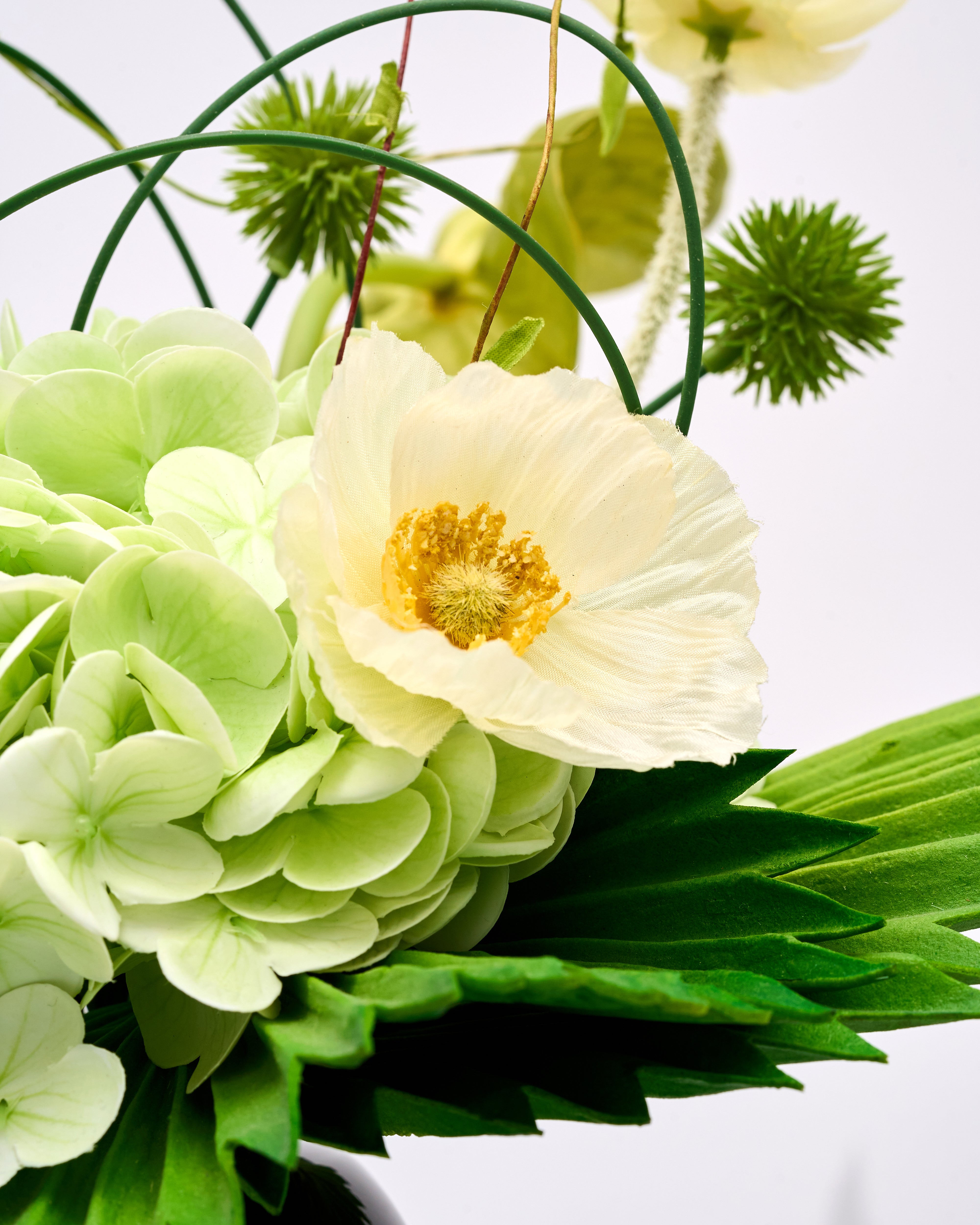 Close-up of a bouquet with white and green flowers on a light background