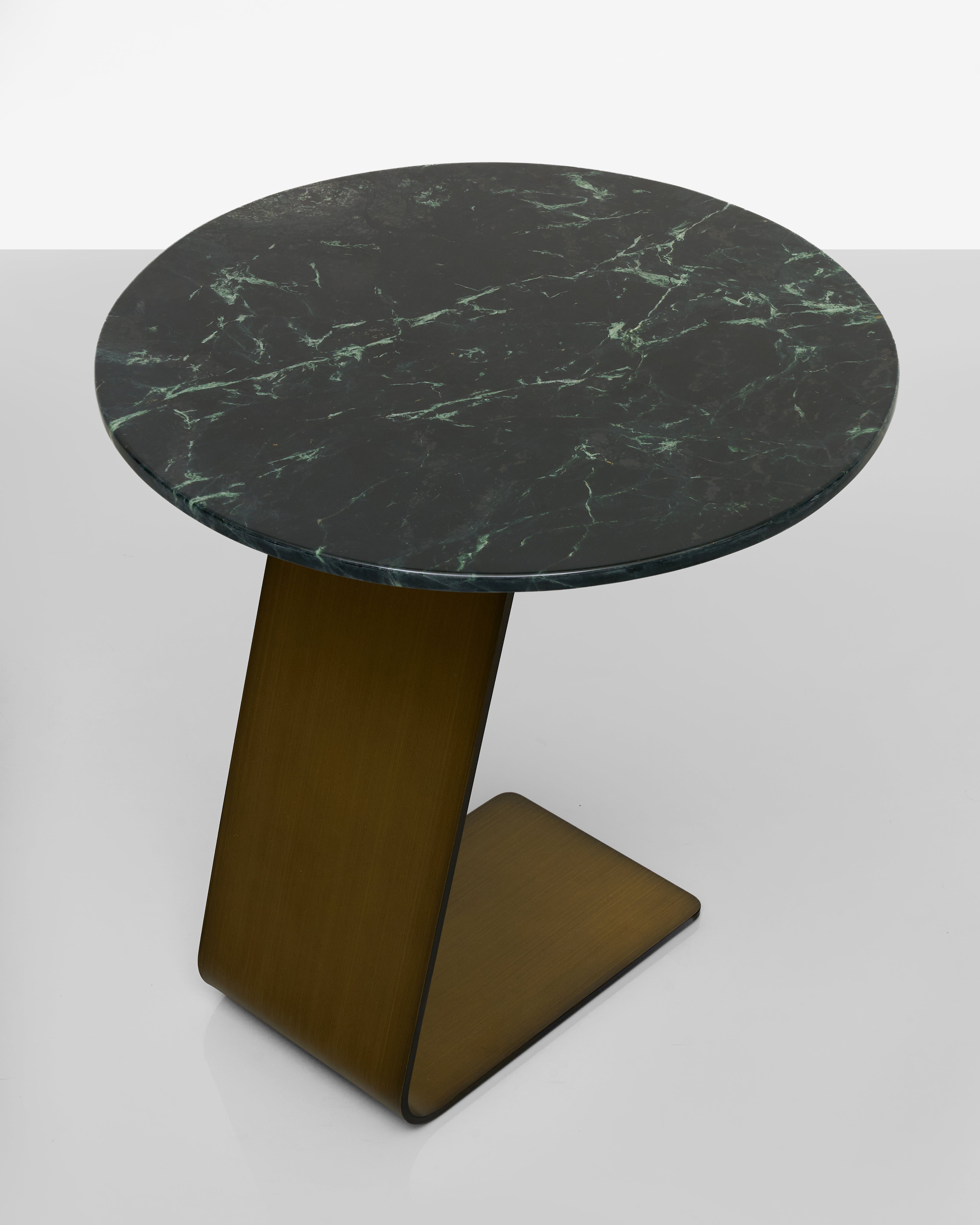 Round marble table with a dark green pattern on a white background