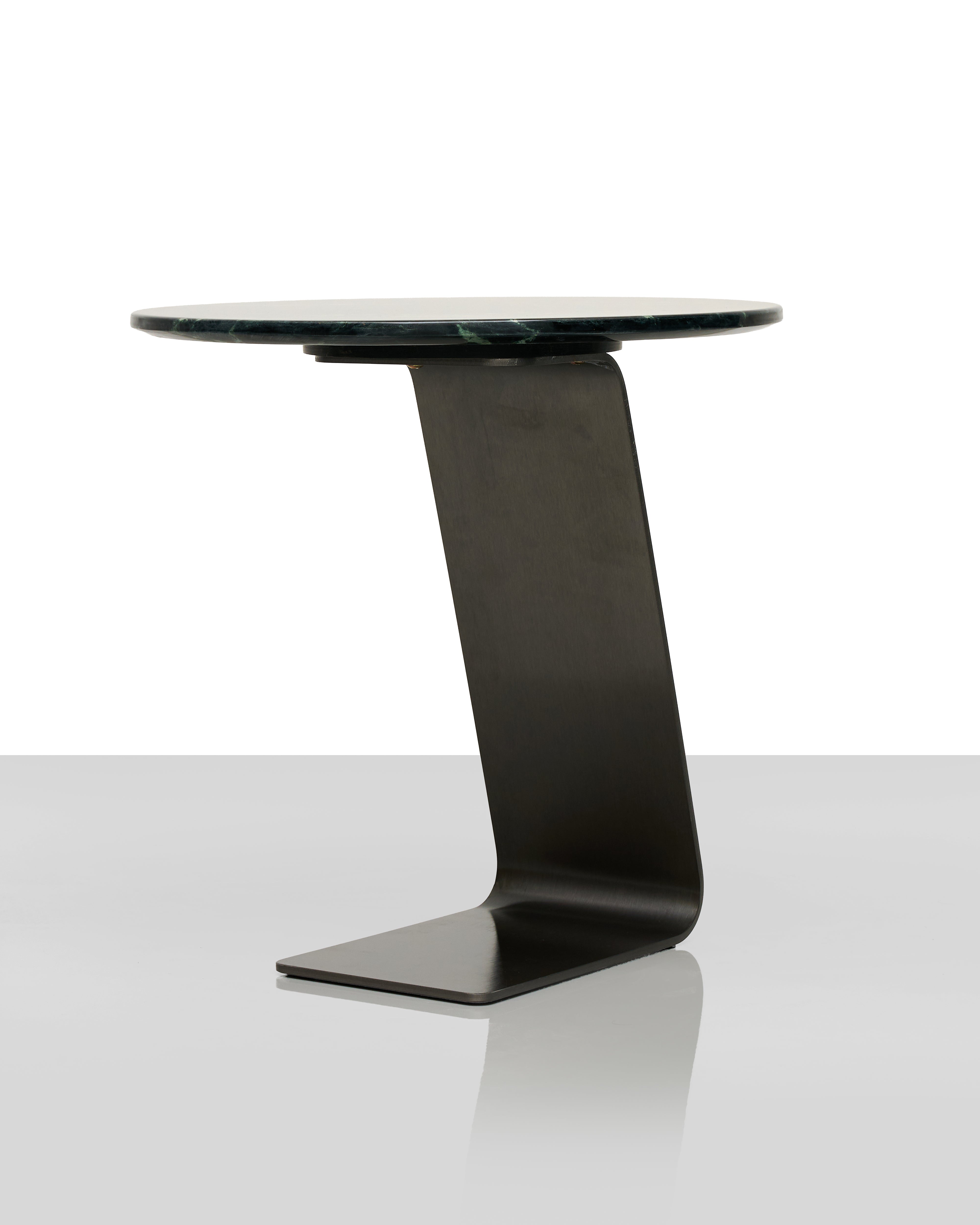 Modern side table with black base and glass top on a white background