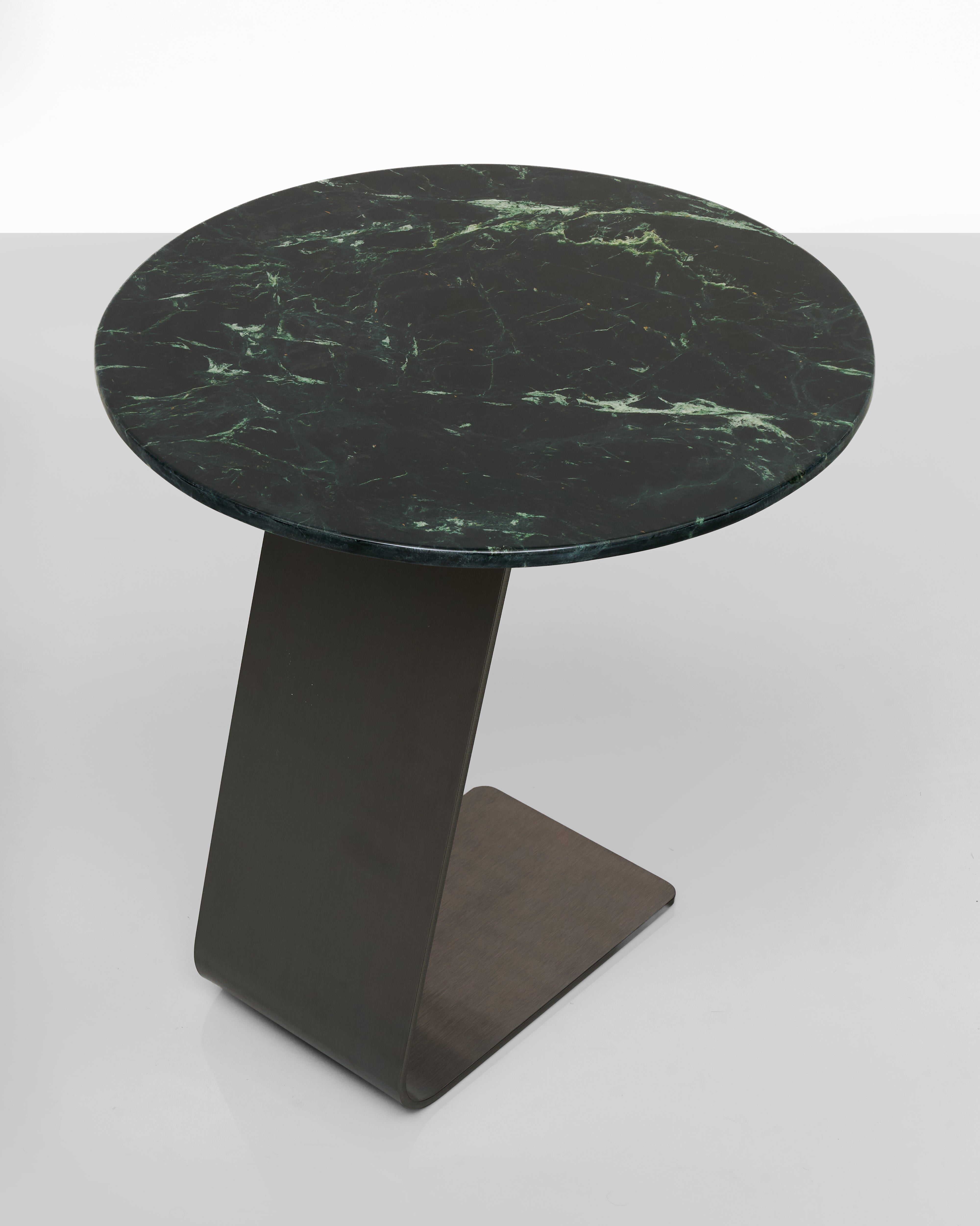Round marble table with green veining on a white background