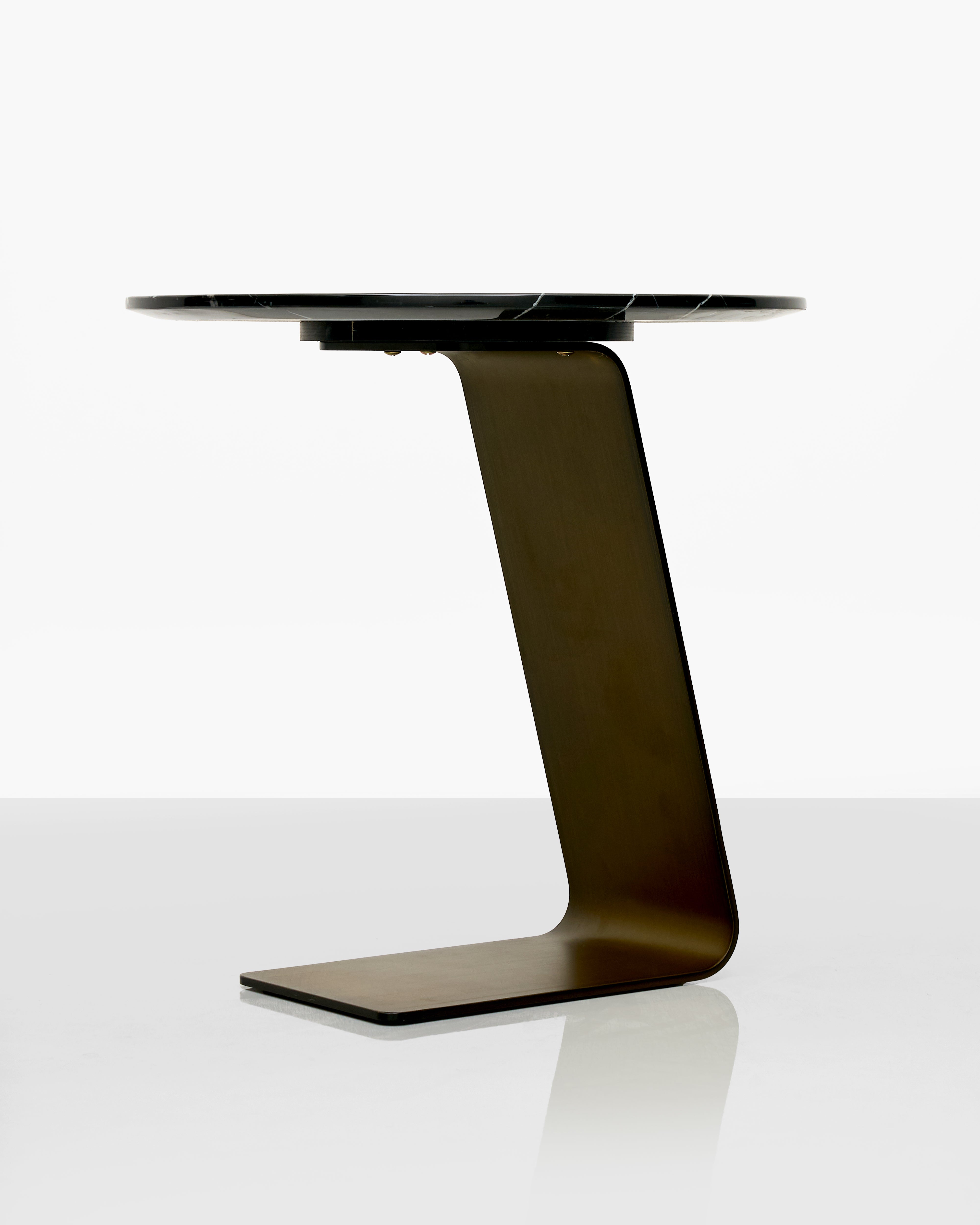Modern black side table with unique base L shape base design on a white background