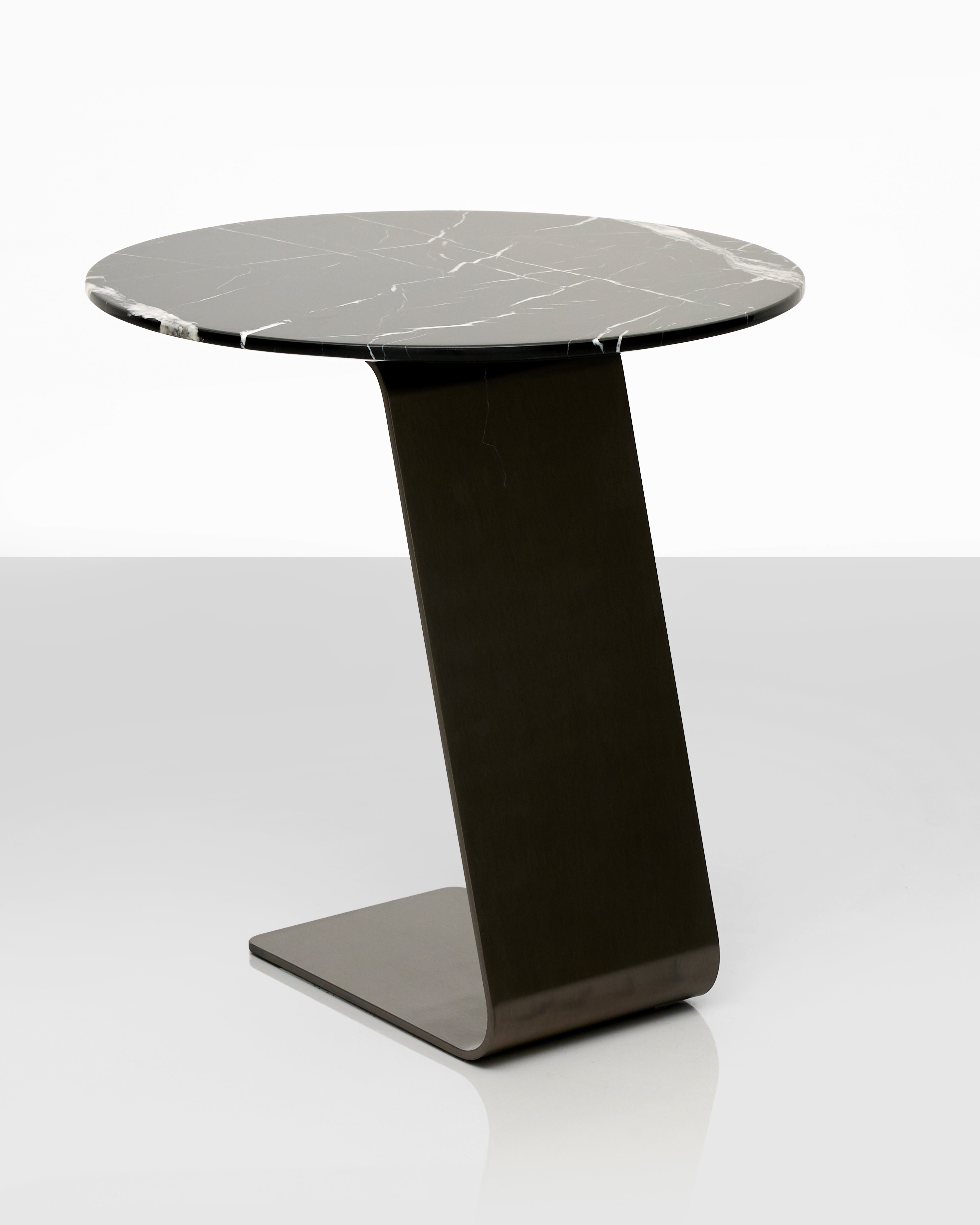 Modern side table with marble top and black base on a white background