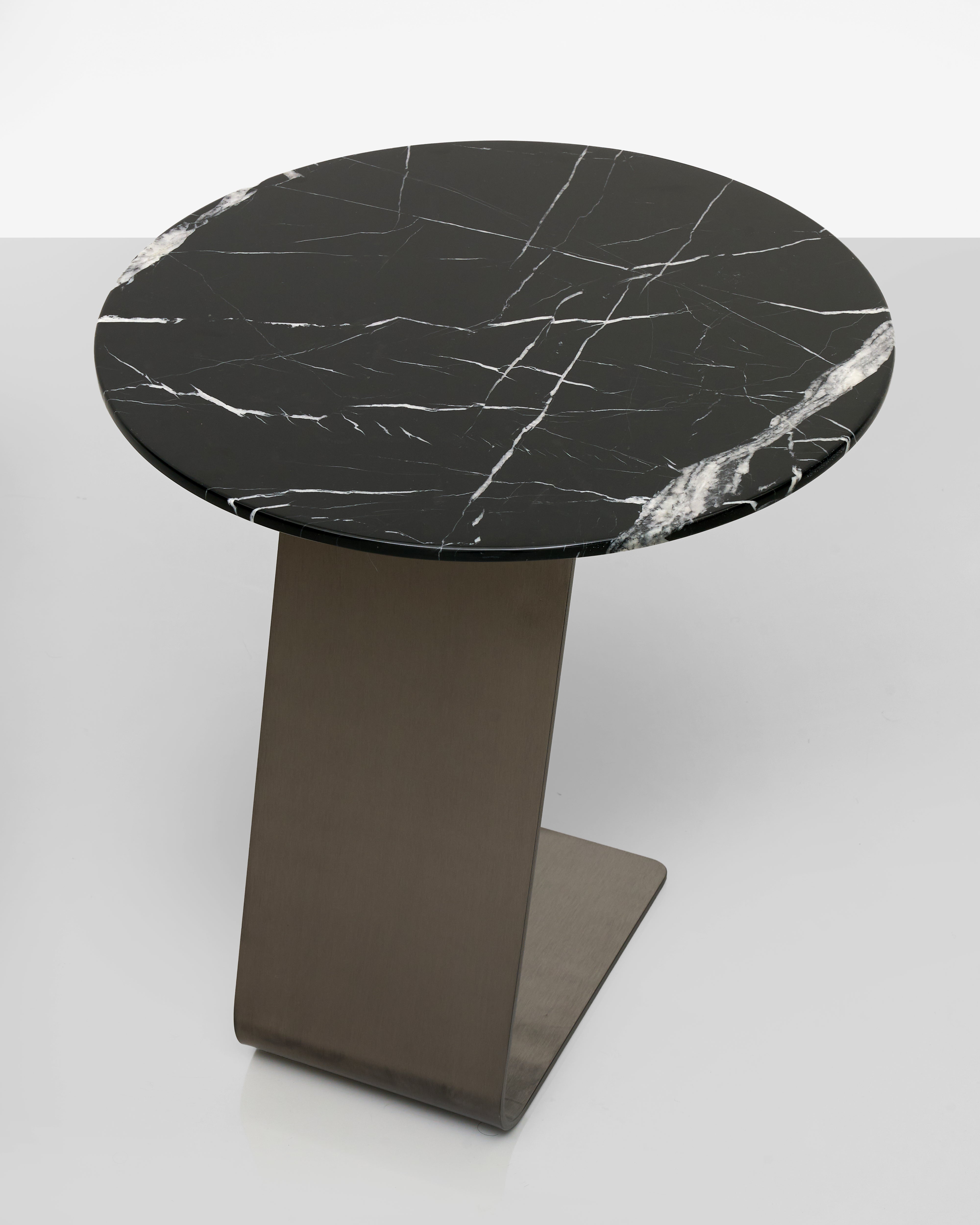 Round marble table with a black and white pattern on a gray background