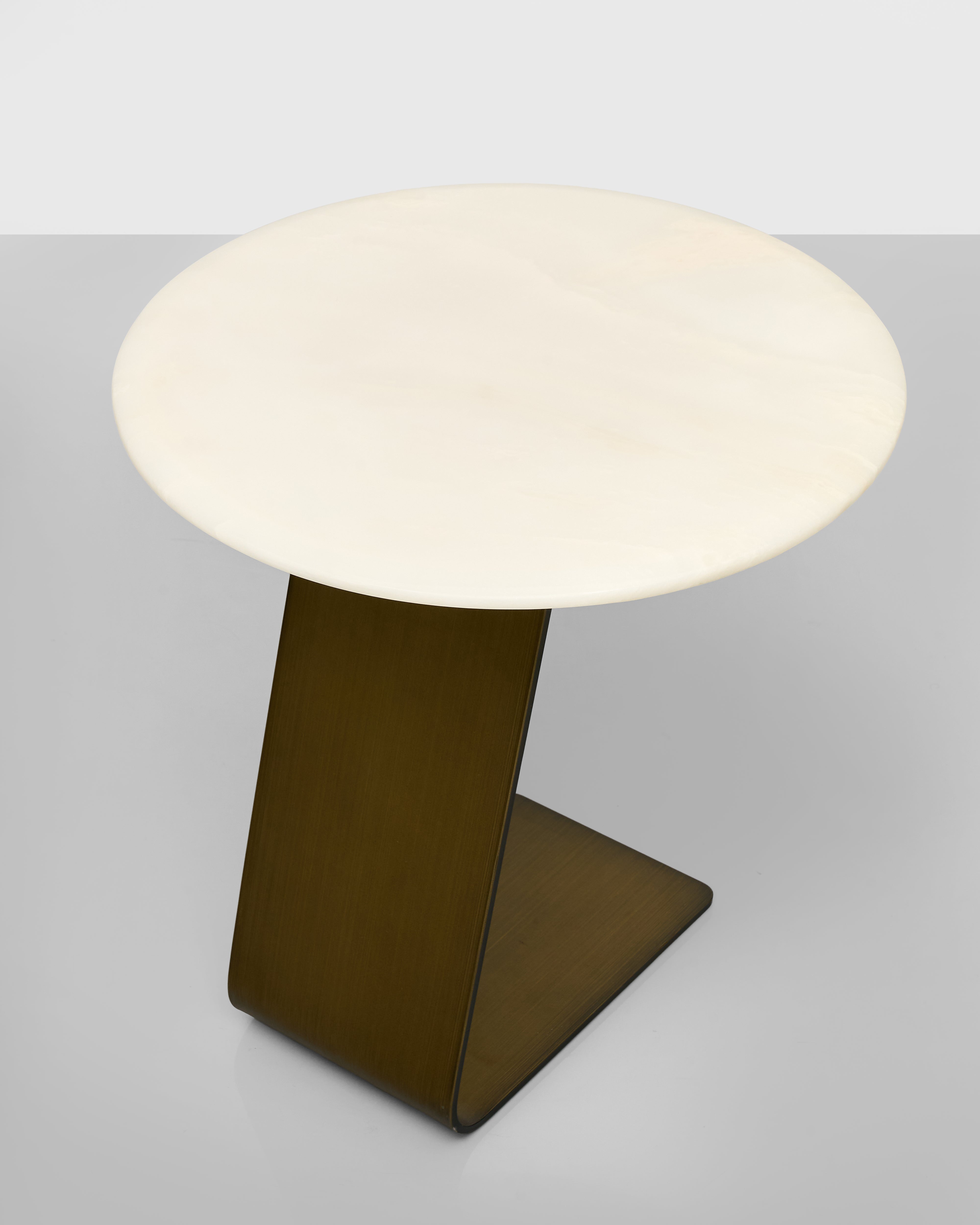 Small round table with a white top and brown base on a light gray background