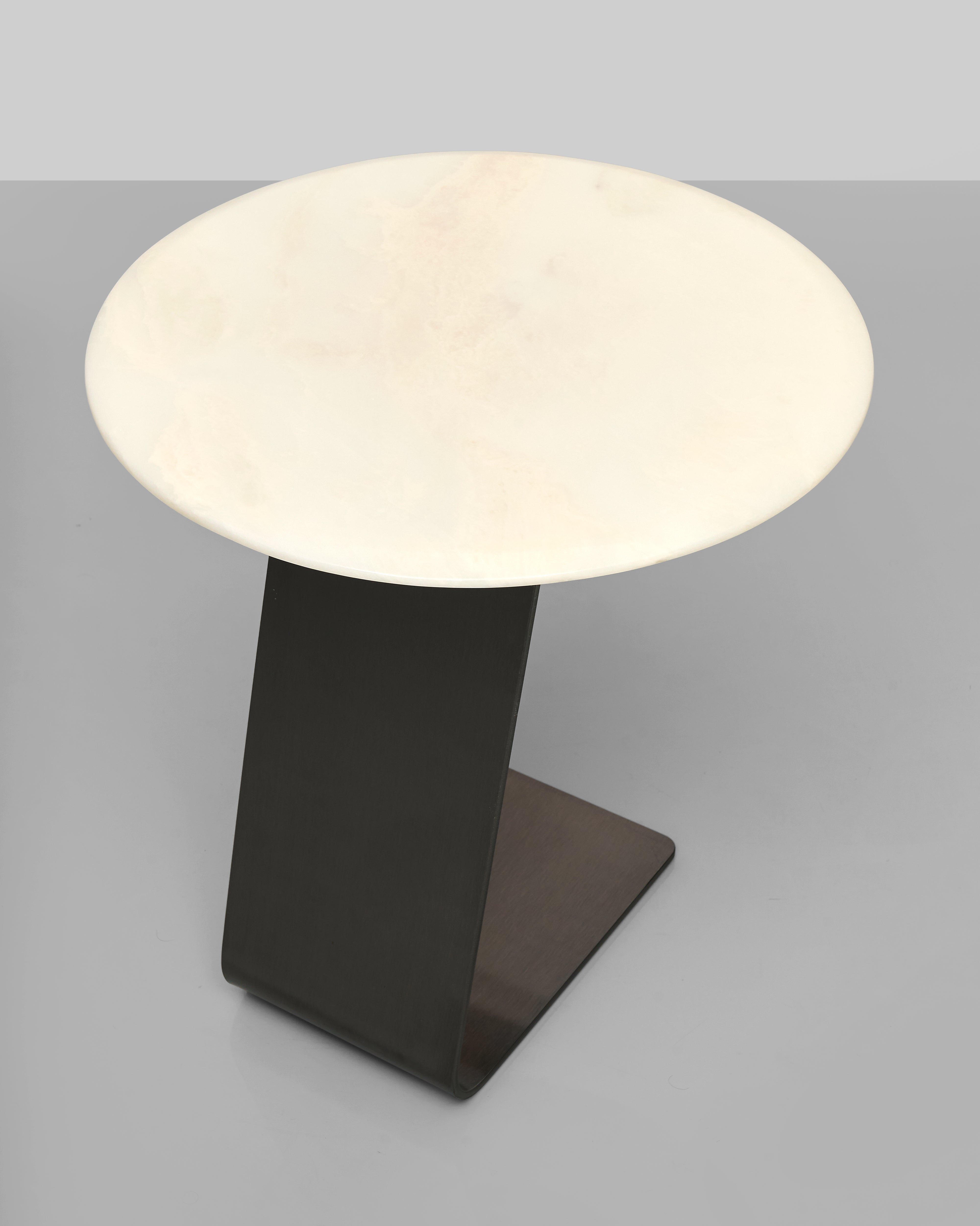 Small round table with a white top and black base on a gray background