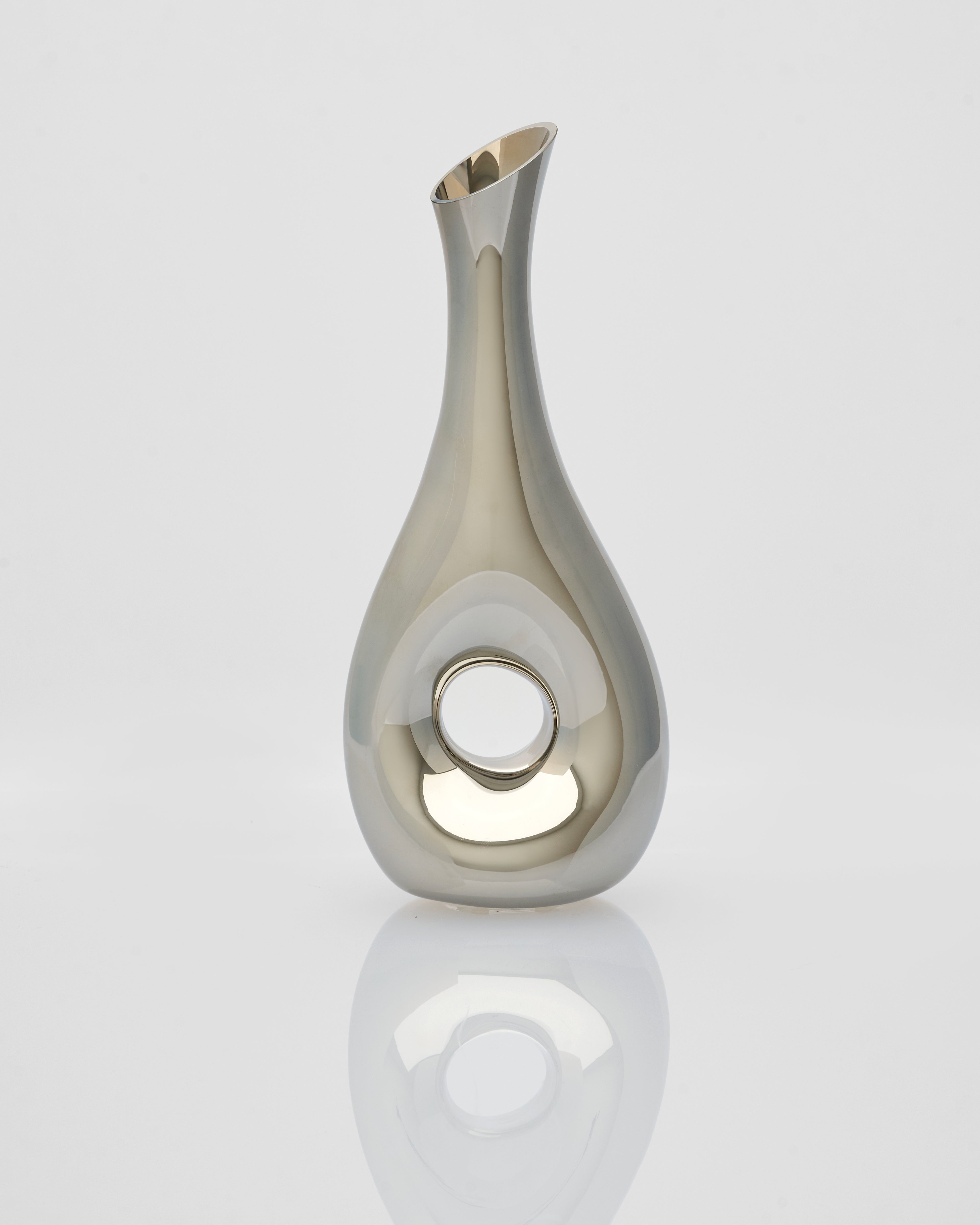 Silver vase with a reflective surface on a white background