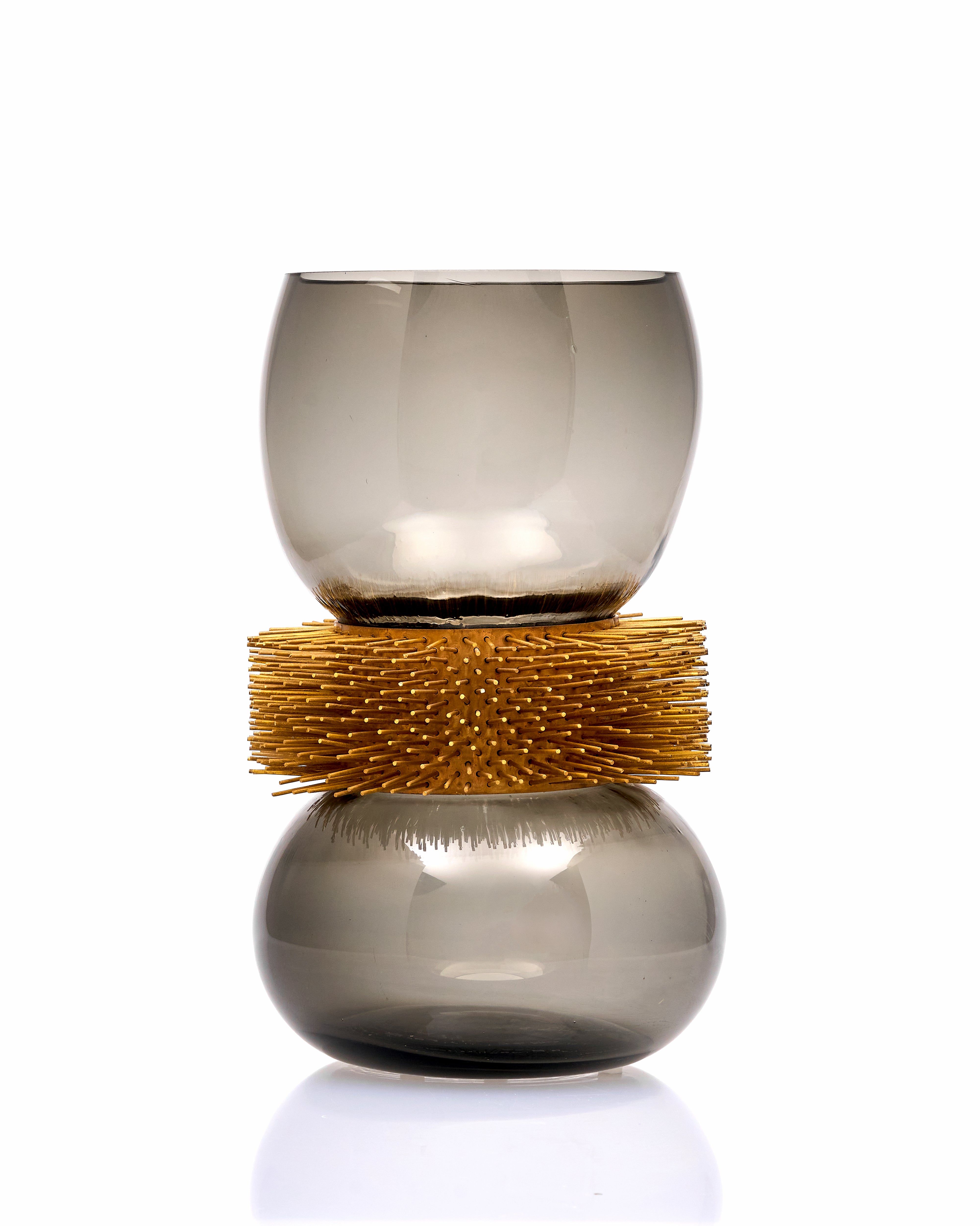 Decorative vase with gold band and glass design on a white background