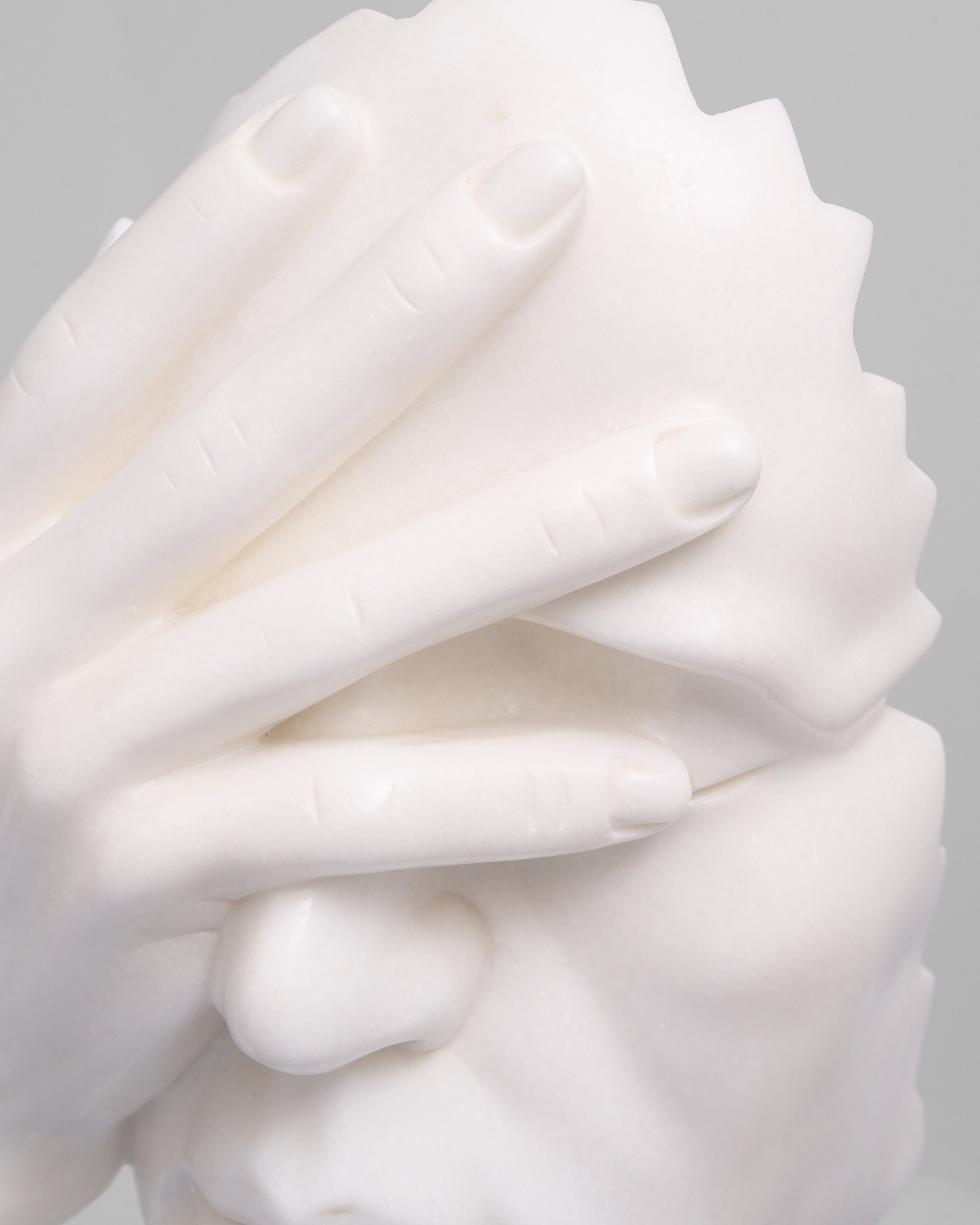 Close-up of a white, swirled cream puff against a gray background