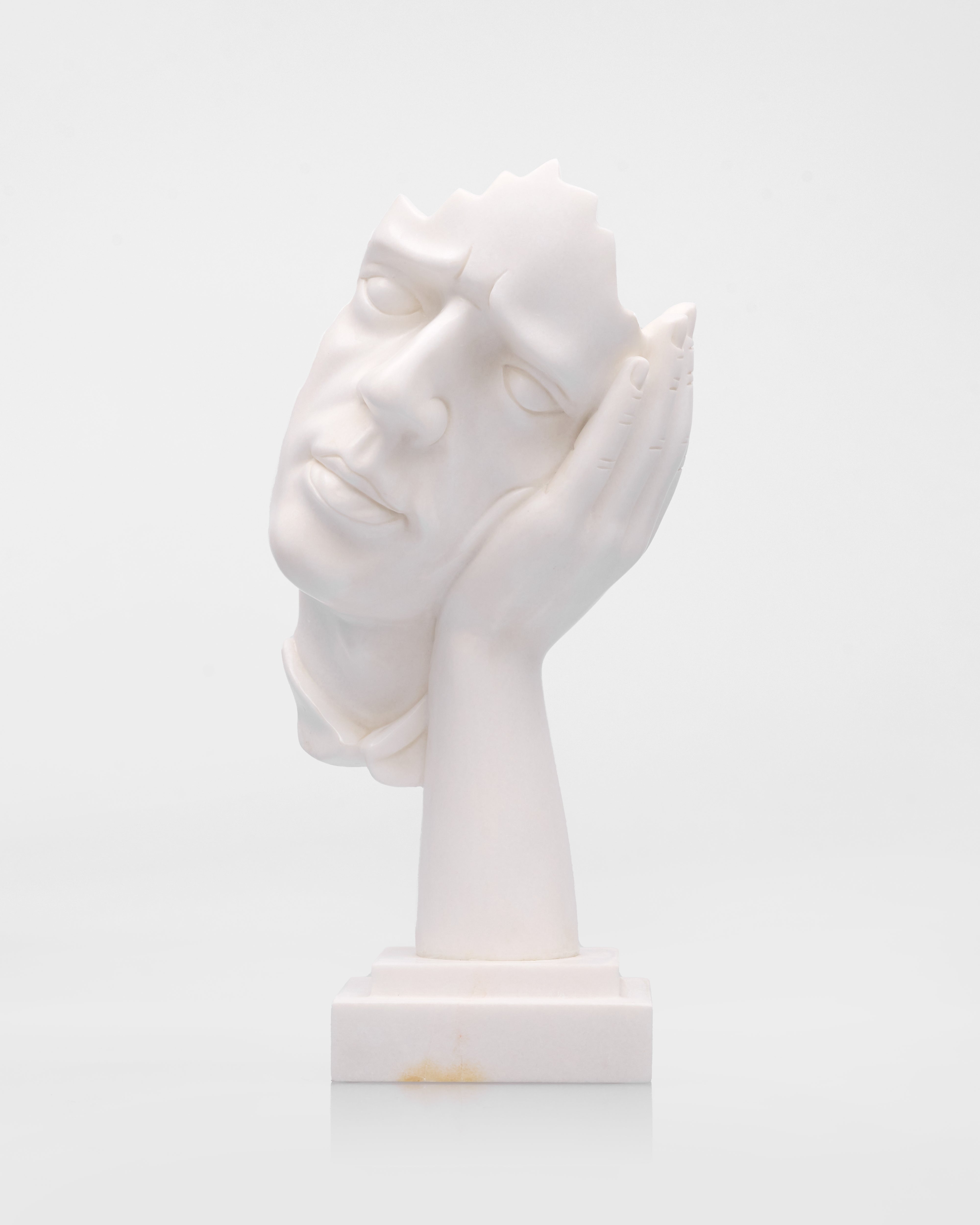 White marble bust of a woman's head on a white background