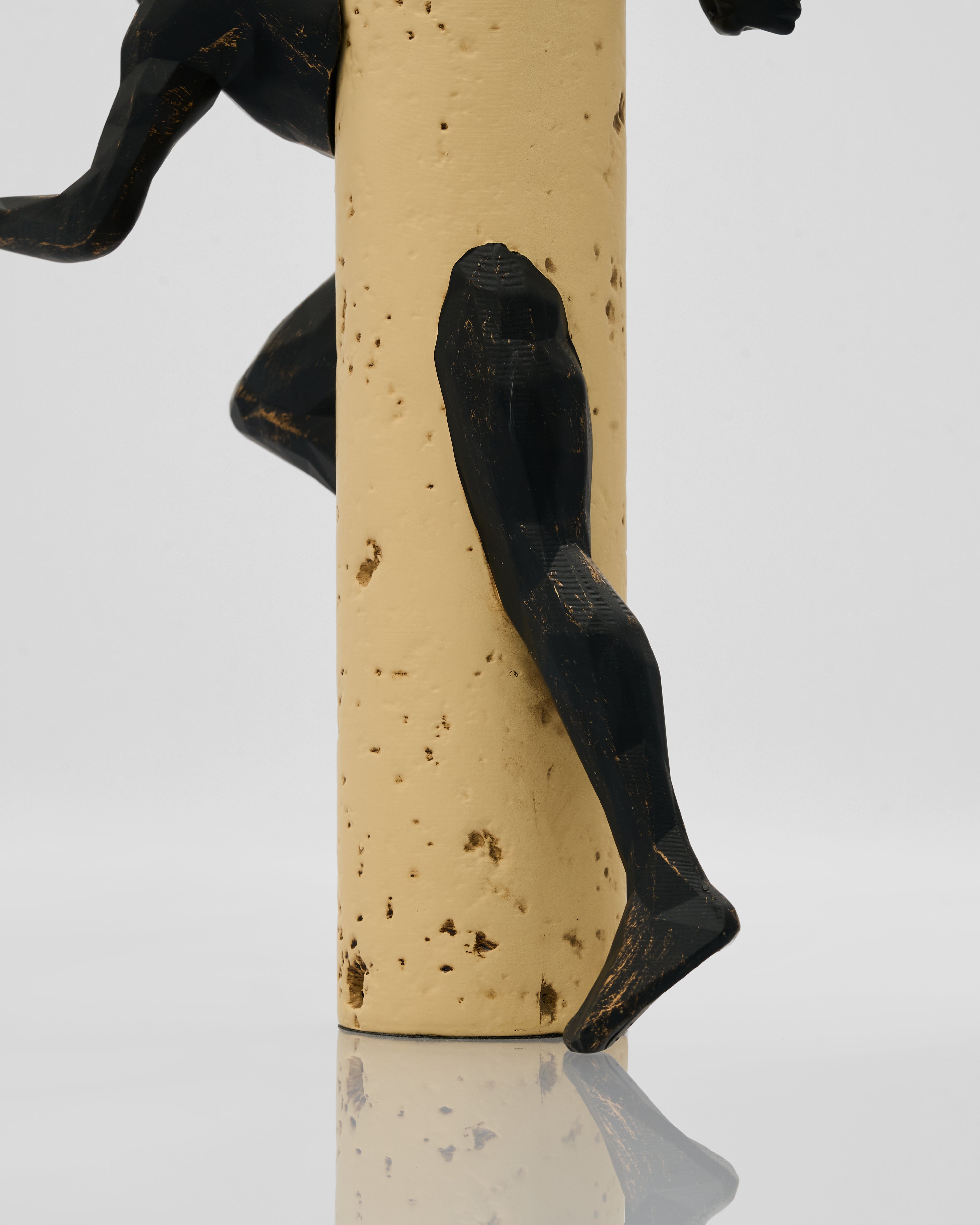 Cork with a black metal figure on a white background