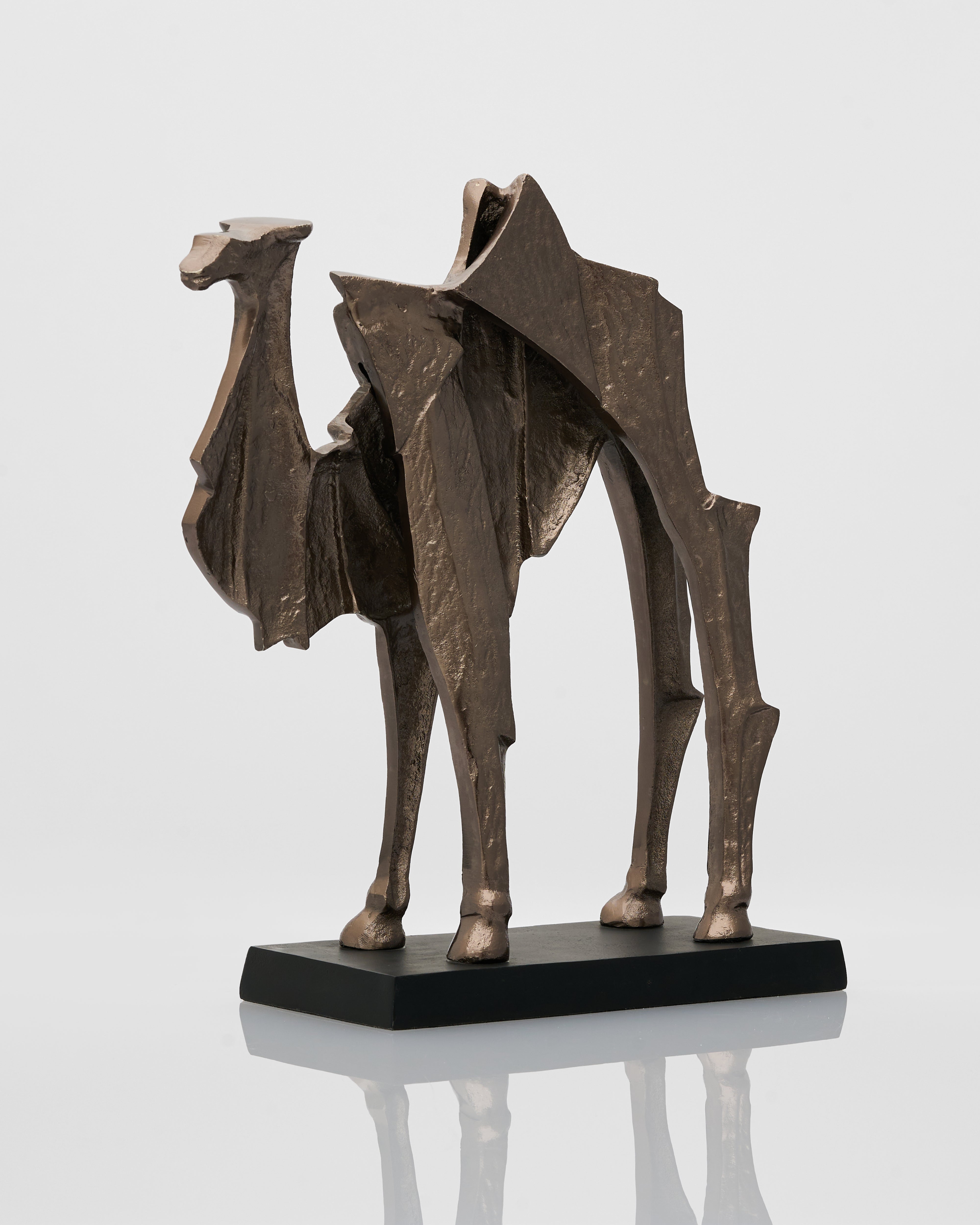 Bronze sculpture of a horse on a reflective surface with a light gray background