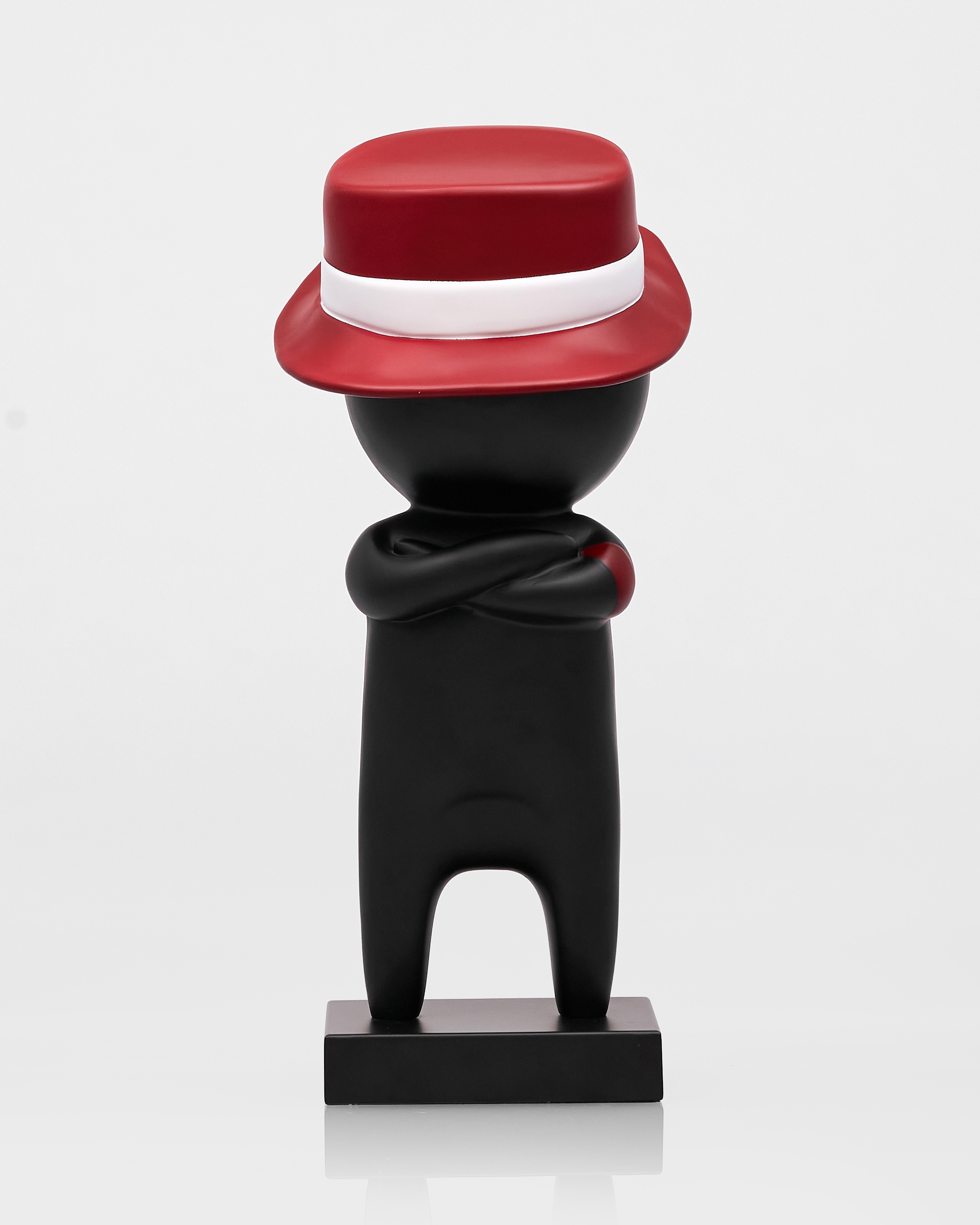 Black figure with a red hat and scarf on a white background