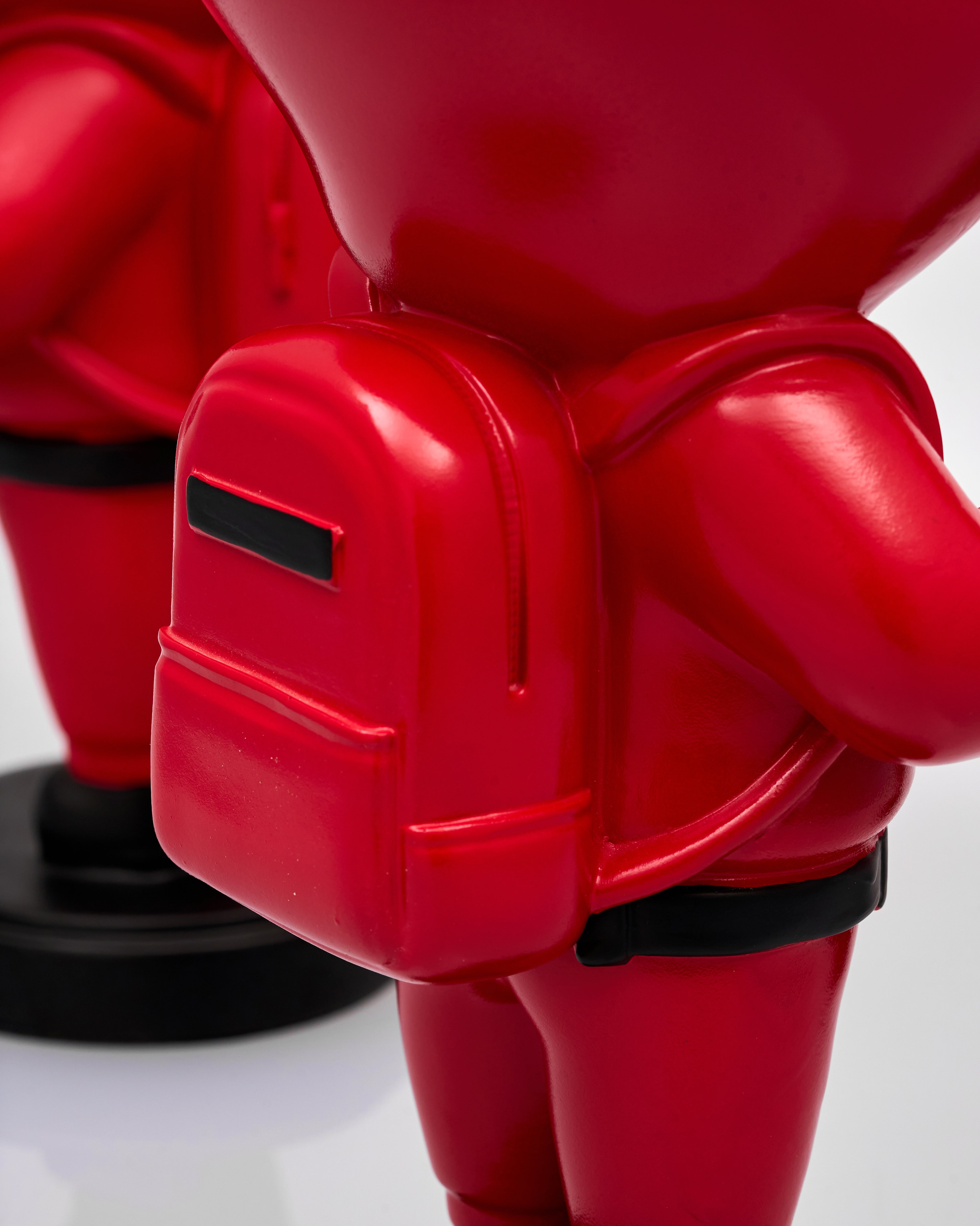 Close-up of a red squid game figure with a white background