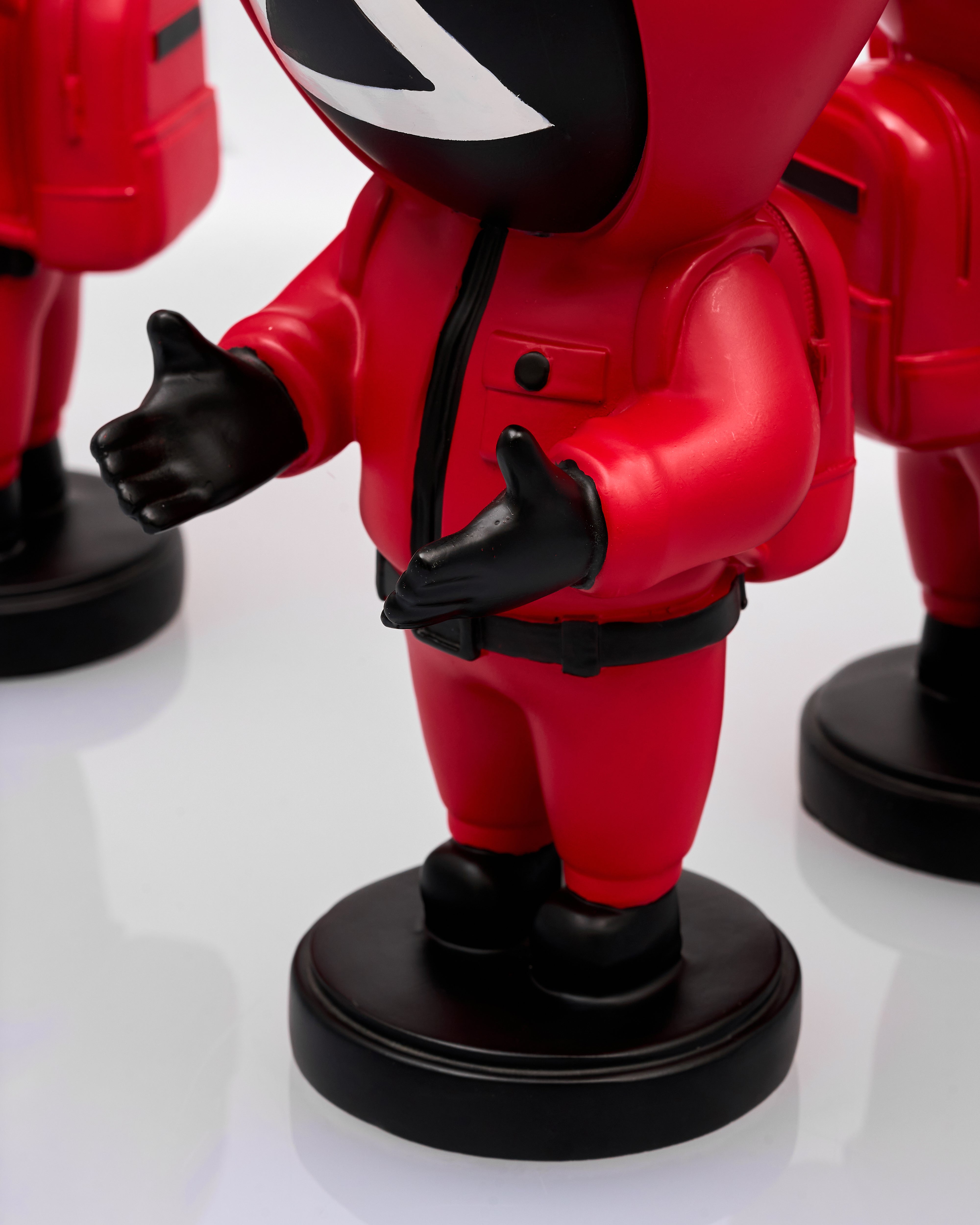 Red and black superhero figurine on a white background
