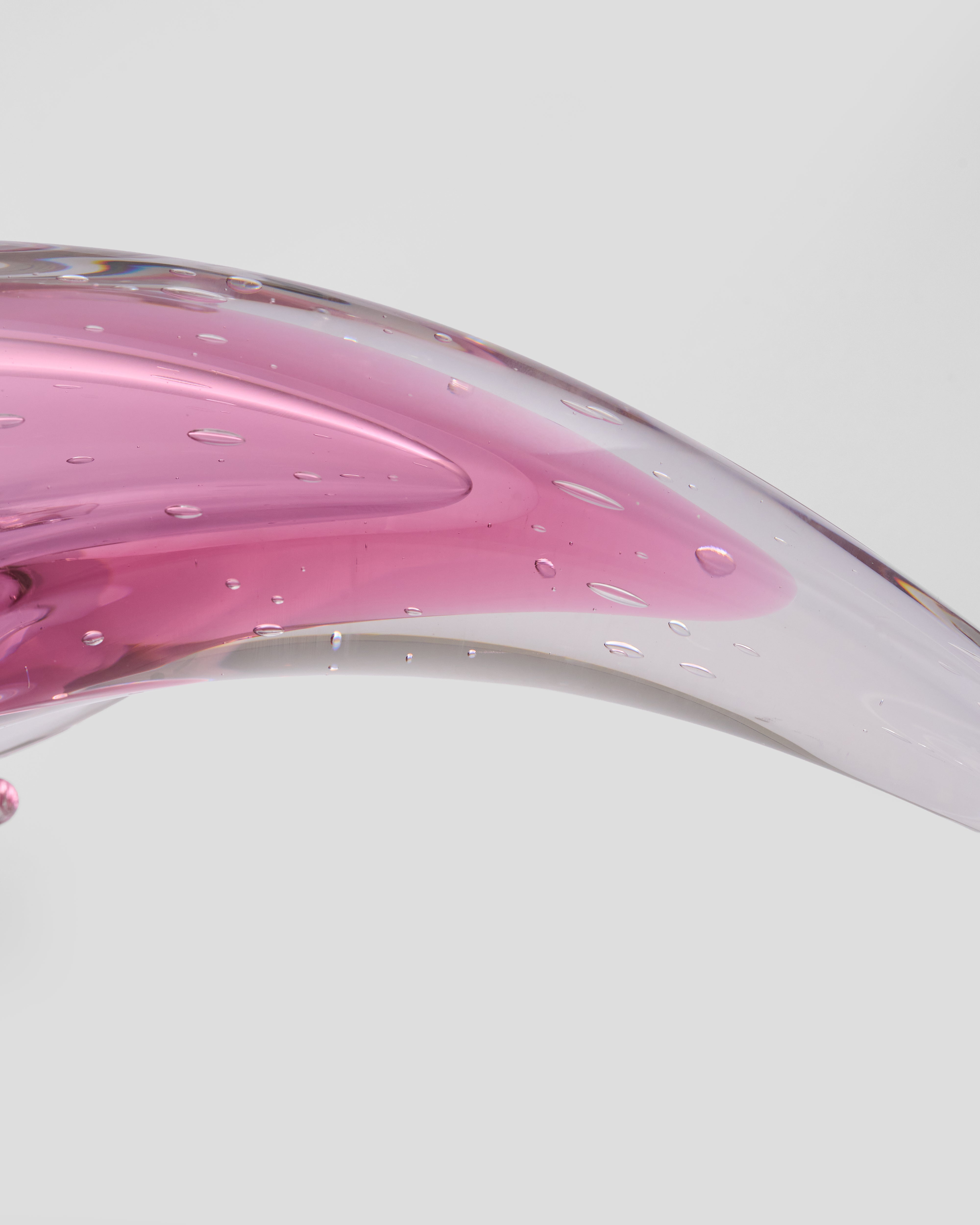 Glass object with pink and clear gradient on a white background