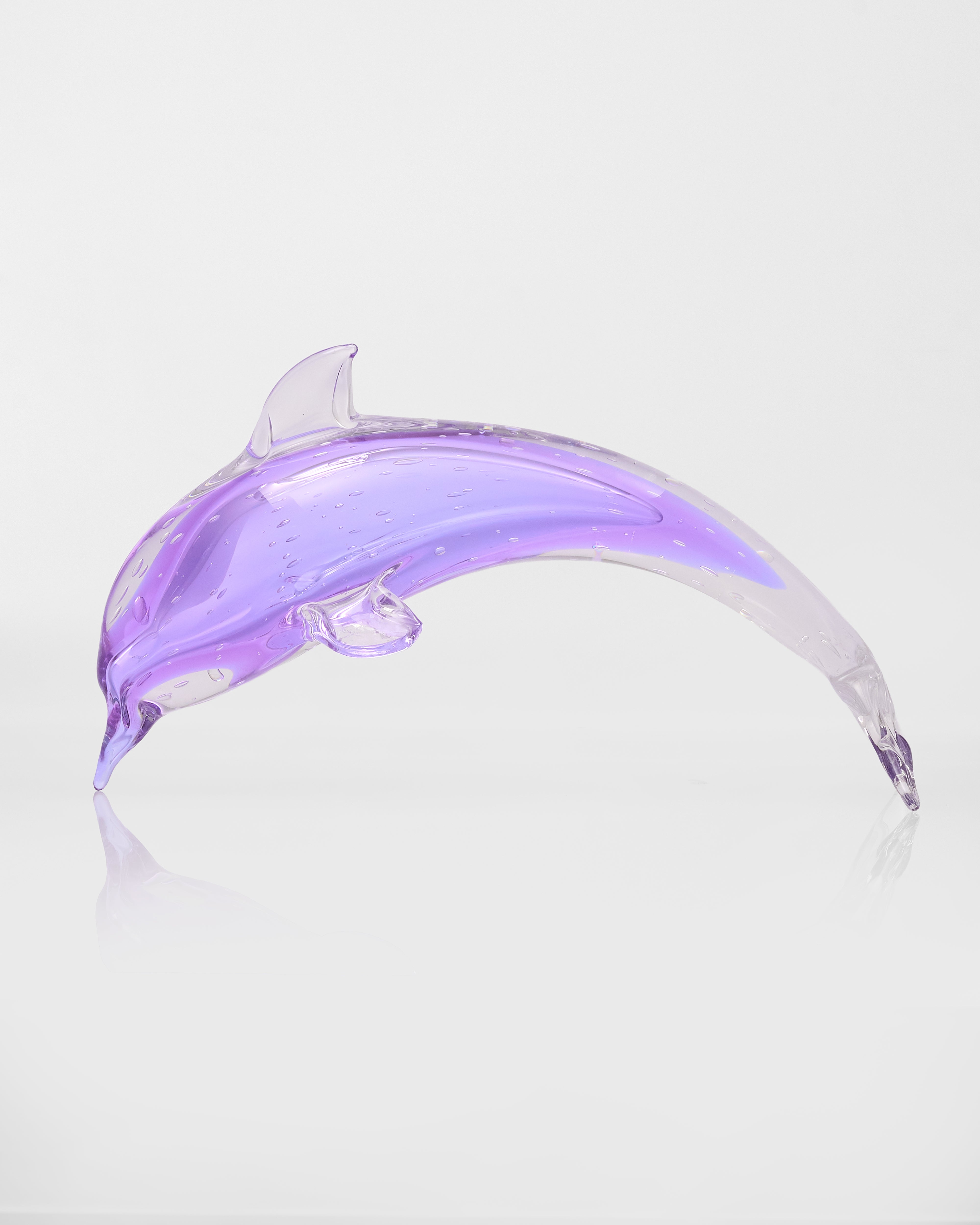Purple dolphin-shaped object on a white background