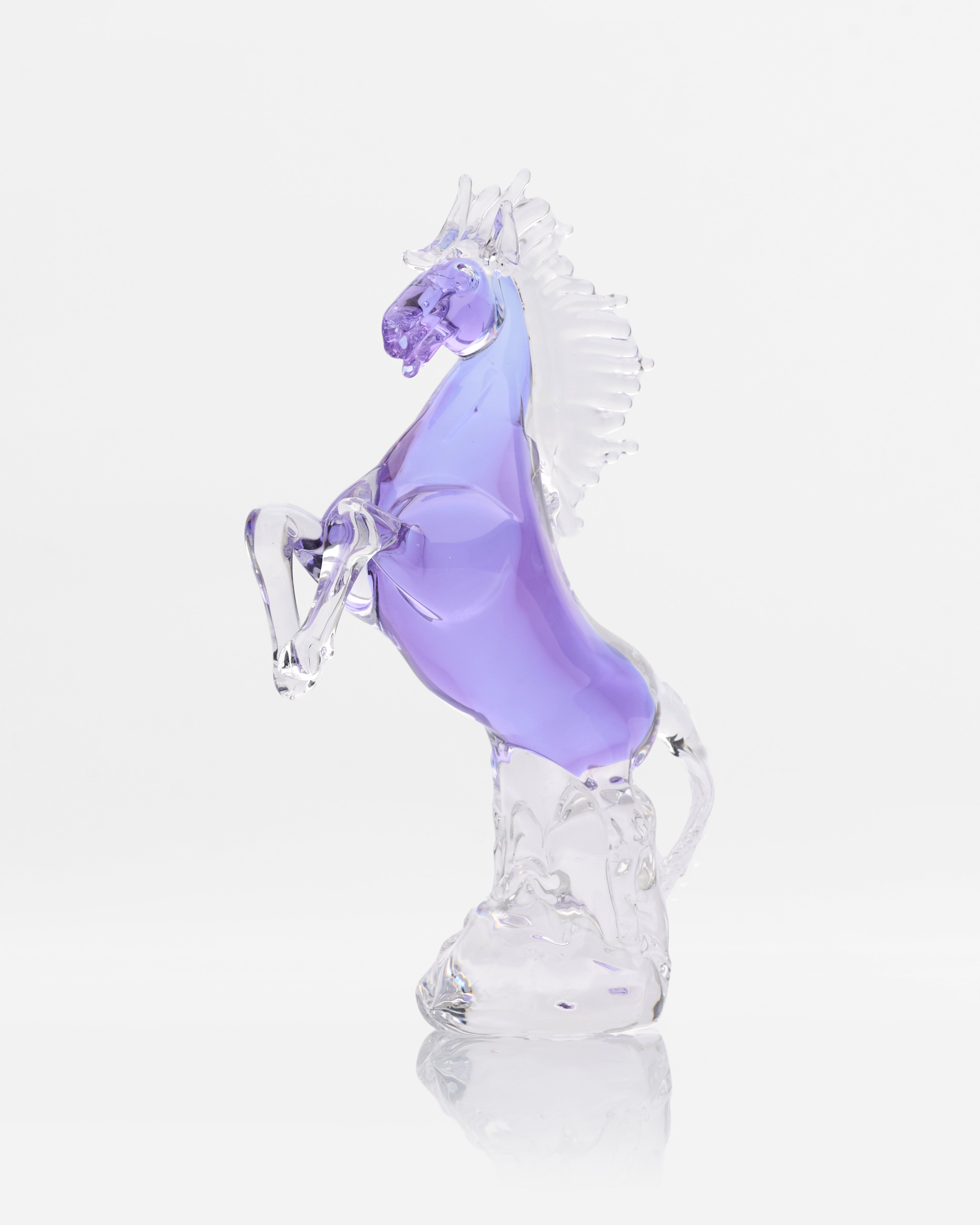 Glass horse figurine with a purple body on a white background