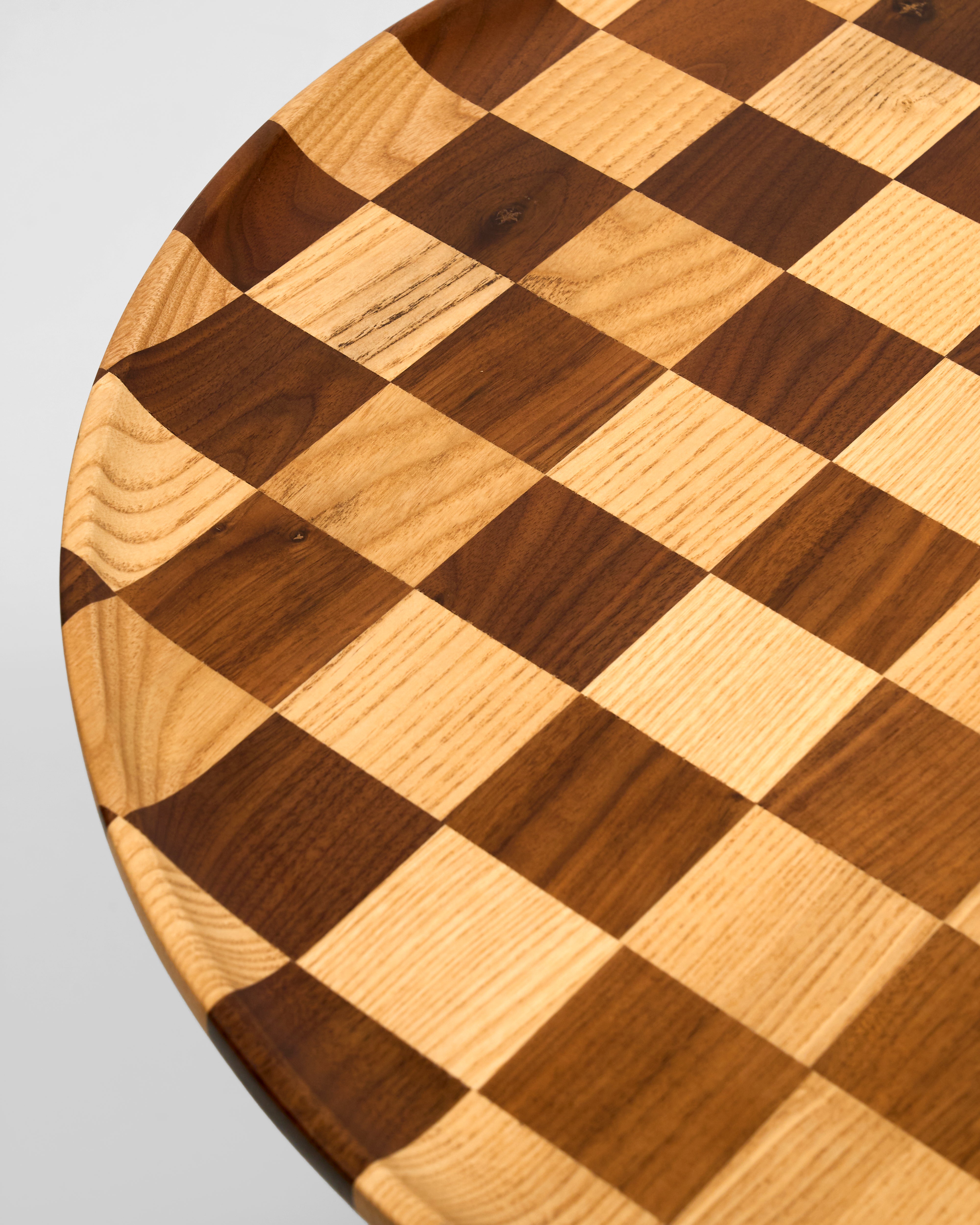 Wooden check box with a checkered pattern on a light gray background